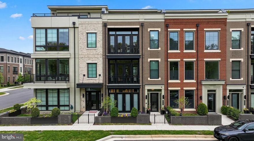 Welcome to one of One Loudoun’s most exceptional luxury townhomes—an ideal residence for those seeking to simplify without compromise. Perfectly positioned overlooking Central Park, this four-level home offers refined, turnkey living with the rare convenience of a private elevator connecting every floor. Thoughtfully designed for both everyday comfort and elegant entertaining, it delivers a seamless blend of sophistication, functionality, and effortless lifestyle.

From the moment you enter, the home sets a distinctive tone. The entry level features an expansive club room with custom built-ins and a sleek wet bar with beverage refrigeration—an inviting space for hosting or relaxing. A fully built-out personal lobby provides exceptional storage, while dual-zone wine coolers (188-bottle capacity) offer a striking introduction to the level of detail found throughout.

The main living level is a true showpiece, anchored by a chef-caliber kitchen designed to rival the finest custom homes. An oversized island, premium Wolf and Sub-Zero appliances—including a six-burner double oven range, convection steam oven, and dedicated wine tower—combine performance with striking design. Custom cabinetry, integrated lighting, and a designer backsplash complete the space. The sunlit dining and family rooms overlook Central Park, with a Juliet balcony enhancing the open feel. At the rear, a more intimate hearth room with gas fireplace opens directly to a private deck, creating a warm and versatile living environment.

The bedroom level offers a serene retreat. The primary suite features custom-designed closets and a private balcony with peaceful park views. The spa-inspired bath includes heated floors, a walk-in shower, soaking tub, and elevated finishes throughout. Two additional bedrooms share a well-appointed bath, and a thoughtfully designed laundry room with custom built-ins adds convenience without sacrificing style.

The top level is dedicated to elevated living and entertaining. A spacious recreation room with built-in surround sound is complemented by an impressive bar with refrigeration, creating an ideal gathering space. Step out to the expansive rooftop terrace, where a natural gas firepit and multiple seating and dining areas overlook the park—perfect for both relaxed evenings and larger gatherings. A fourth bedroom, full bath, and additional storage complete this level.

What truly sets this home apart is its effortless, lock-and-leave lifestyle. With minimal exterior maintenance, elevator access to all levels, and fully integrated Control4 smart home technology for lighting, audio, and shades, every detail is designed for ease and comfort—whether at home or away.

Located in the heart of One Loudoun, this residence offers unmatched walkability to premier dining, shopping, and entertainment. With convenient access to major routes, Washington Dulles International Airport, and Inova Loudoun Hospital just minutes away, it provides both connectivity and peace of mind.

For those transitioning from larger homes or seeking a refined, low-maintenance lifestyle without sacrificing quality or space, this is a rare opportunity to enjoy luxury living in one of Northern Virginia’s most vibrant communities.

This home truly has it all—don’t miss your opportunity to make it yours.