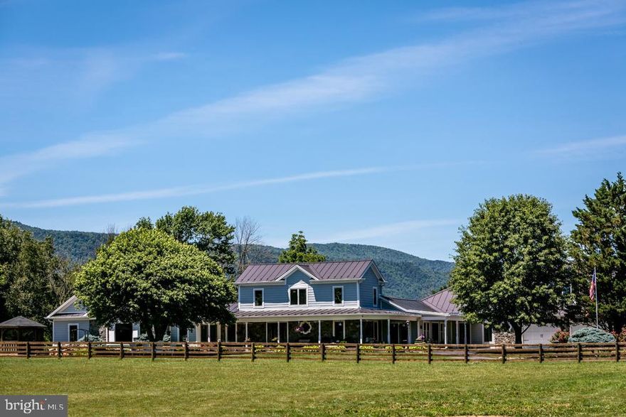 VIEWS & BEAUTY ABOUND! Luxurious comfort awaits on this spectacular farm in a beautiful location near Skyline Drive, Shenandoah National Park, Massanutten Resort, countless wineries and breweries, minutes from Harrisonburg! Extraordinary customization and attention to detail throughout this gorgeous home make this property truly exceptional, including quad-zoned HVAC, 4 separate fenced paddocks (with alleyway), outdoor storage sheds, a detached garage (with a lift and workbench), a beautiful horse barn, immaculate landscaping, gutter guards, & 30 amp RV outlet. The MASTER WING offers a wet bar, gas see-through fireplace, gas fireplace in bathroom, 2 large mounted TVs, 2 walk in closets, sauna, Jacuzzi, remarkable walk-in shower and exercise room.  HORSE STABLE boasts 5 stalls, conditioned office, full bath, tack room, feed room, wash bay, shavings bay, hay storage in loft, fans, and music for the equine residents. The PAVILION is perfect for entertaining with full kitchen, stone wood-burning fireplace. So many possibilities here! Not only your perfect home and farm, but also incredible opportunity for a venue or short term rentals. This jaw-dropping home has it all! A more comprehensive list of special features has been uploaded in  Bright.