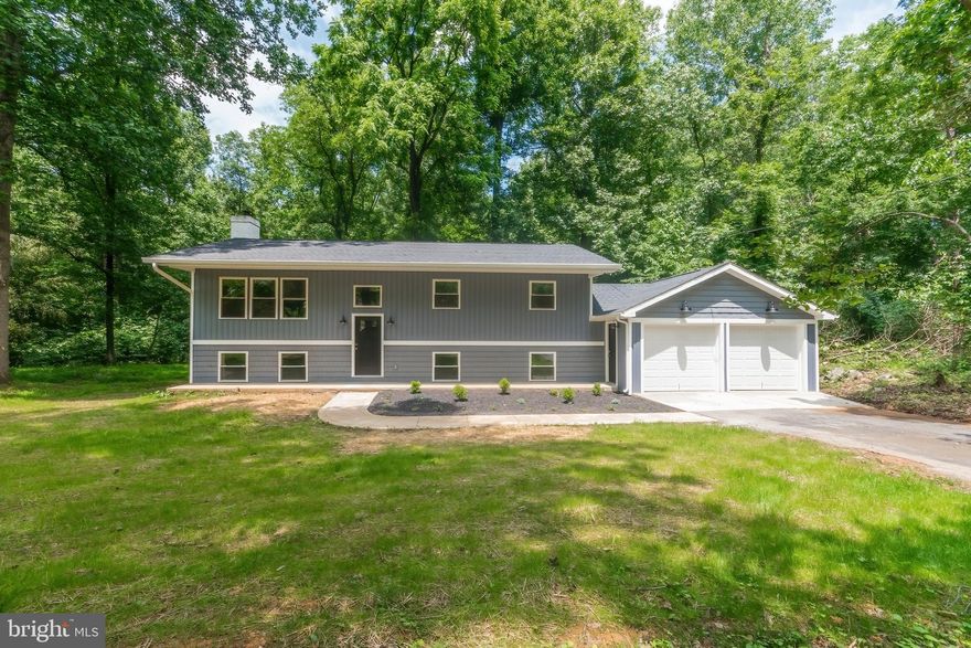 This newly renovated home on almost an acre is situated in Chaplines Choice. The home features 3 bedrooms, 3 bathrooms, and a flex room in the basement that is perfect for a home office, gym  or whatever you desire.   As you approach the home you will love the exterior which includes new windows, vinyl siding, architectural shingle roof and exterior doors.  Upon entering the front door, you will find new LVP floors throughout, recessed lighting,  updated light fixtures and a new HVAC.  The kitchen is fully equipped with new 42" soft-close cabinets, Whirlpool appliances and quartz counters.  The primary suite is located on the upper level and boasts two closets and a bathroom with a custom tiled shower and double vanity with quartz counters.  Step outside the kitchen door or the owner's suite door to a large deck that is totally secluded and perfect for nature lovers.  The other 2 bedrooms share a full bathroom that has also been updated with new tile and vanity.  The basement features  a family room with a wood burning stove,  another full bath with a custom tiled shower, a laundry room,  and a  flex room with a closet for extra storage.
