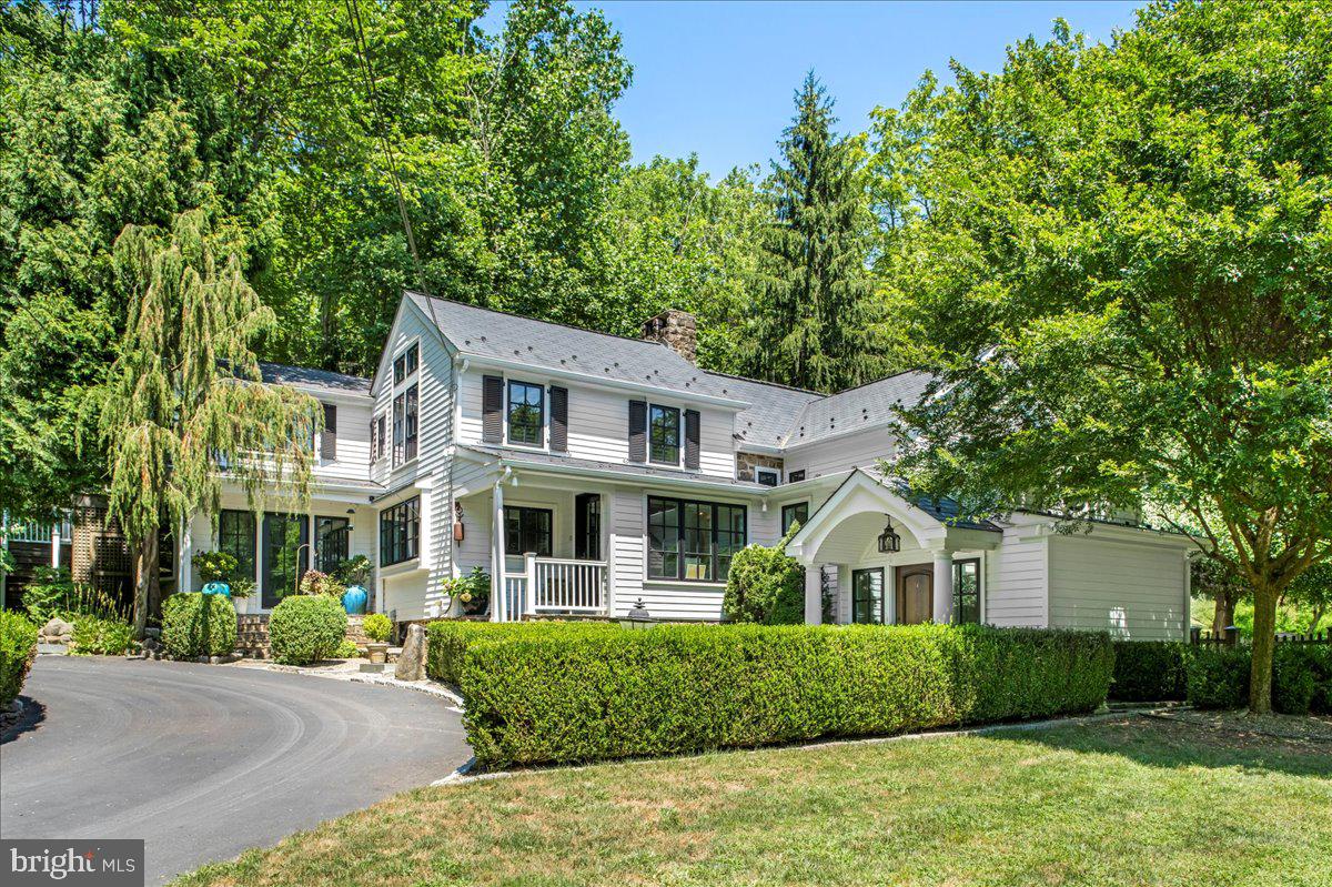 A gorgeous transitional farmhouse tucked away on over 5 acres in Upper Makefield. Welcome to this gated retreat which includes a lovely pool, pool house, separate studio, guest apartment and charming outdoor spaces that make this a truly enchanting property. The main house is adorned with beautiful designer finishes around every turn and includes a dramatic entry with gorgeous windows and custom lighting, a beautiful built-in bar, cozy Dining Room with access to a private courtyard and secret garden. The Gourmet Kitchen is bright, featuring custom wood cabinets with intricate detailing, marble counters and backsplash. The Gathering Room highlights a wood-burning fireplace and offers gorgeous views from all angles and access to private half bath with a striking floating Quartz vanity. Upstairs one will find 2 Bedroom Suites each offering huge walk-in closets and upgraded marble baths. The separate Guest quarters can be accessed from the outside of the main home and features a completely private living experience with its own kitchen, full bath, bedroom and living space. The detached 2 car garage also houses an amazing studio space for work, play or more guest space! Completely air conditioned and heated with a private entrance, this amazing recently updated space is complete with a full bath, bedroom, a Study and gym area. Hidden away is a tranquil respite offering a rectangular, Hampton-style pool, stone fireplace, outdoor speakers, pool house with a kitchenette, full bath and a mini outdoor sports court. Truly something for everyone and a property that you won’t want to leave!