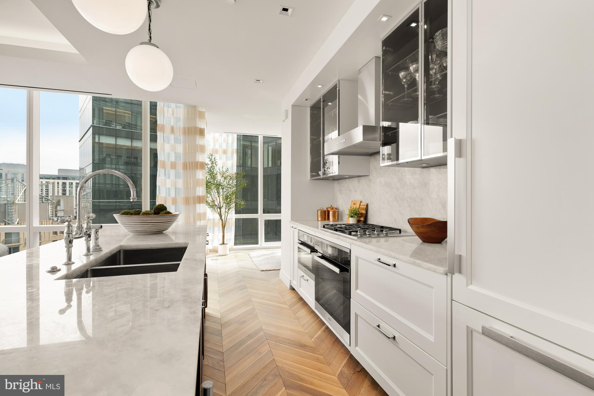 INCENTIVIZED PRICING - JUST REDUCED FROM $900,000!! BRAND NEW ONE-BEDROOM CORNER UNIT WITH BALCONY AVAILABLE!
Welcome to the Four Seasons Private Residences in Harbor East, where luxury meets lifestyle in Baltimore’s most coveted waterfront address. This stunning one-bedroom, one-and-a-half-bathroom corner unit w/ balcony was thoughtfully designed to utilize every inch with purpose, so it lives larger than 1,222 sq ft! Step into an atmosphere of sophistication with soaring ceilings, rich walnut chevron-patterned flooring, and designer finishes throughout. Expansive floor-to-ceiling windows bathe the home with natural light while showcasing views of the city skyline and Inner Harbor. The gourmet kitchen is a chef’s dream, outfitted with Miele appliances, sleek Eggersmann soft-close cabinetry, luxurious marble stone countertops, and a built-in Sub-Zero wine fridge - perfectly blending timeless elegance with modern function. The primary suite is a tranquil sanctuary, offering a custom-built walk-in closet for optimal storage and a spa-inspired, marble-clad en-suite bath featuring a double vanity with designer finishes, and a glass-enclosed walk-in shower with a built-in bench and niche, inviting total relaxation. A spacious powder room provides added comfort and privacy for guests, and the home is enhanced throughout by motorized window shades and thoughtfully selected lighting.
The Four Seasons Private Residences Baltimore offers a turn-key elevated lifestyle. As a resident, you'll enjoy a private entrance where you will be met by our full service concierge and on-site building manager to assist with your every need, as well as exclusive access to the sprawling 28th-floor amenity level, where world-class services meet resort-style indulgence. Amenities include an indoor heated saltwater infinity-edge pool, state-of-the-art fitness center, sauna, coffee station, billiard room, and numerous elegant gathering spaces. Multiple rooftop decks offer panoramic city and harbor views, complete with indoor and outdoor fireplaces, a grilling station, a dining area, and a kitchen, all ideal for entertaining. Completing this unparalleled lifestyle experience are a fully equipped conference room and a dedicated AstroTurf dog-walking area. This residence offers the rare opportunity to live within a full-service, hotel-branded building while enjoying the privacy and sophistication of a true luxury home. All set within steps of Harbor East’s acclaimed restaurants, shopping, and the waterfront promenade. This is a MUST SEE ONE BEDROOM!! Immediate occupancy is available. Come see what all the fuss is about!
*Photos are from our sales office which is a model of the same exact floor plan*
