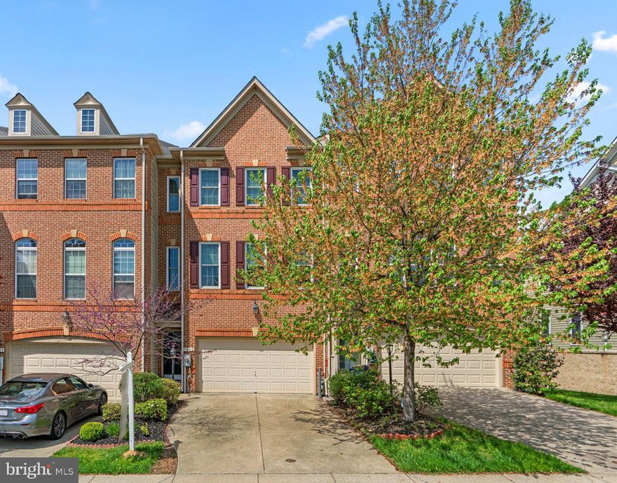 Traditional townhouse residence offering 2,504 square feet with 3 bedrooms, 2 full baths, 2 half baths, and a 2-car garage, available for lease in the desirable Emerson / Cross Creek community. Hardwood floors extend through the foyer and main level, where a spacious, sunlit living and dining area is defined by a modern chandelier and chair railing, seamlessly flowing into the kitchen. The eat-in kitchen is equipped with stainless steel appliances, a center island with a breakfast bar, a chic tile backsplash, a pantry, and generous cabinet and counter space. It opens to a cozy family room with a fireplace and access to a balcony. A powder room completes this level. Upstairs are three carpeted bedrooms and two full bathrooms, including the primary suite with a private balcony, two walk-in closets, and an ensuite bath featuring a large corner soaking tub, dual sinks, and a separate frameless glass shower. The lower level offers a versatile recreation room with hardwood floors, walk-out access to a covered patio, and a convenient laundry area. Residents enjoy access to a community clubhouse, scenic trails, a picnic area, swimming pool, tennis courts, and multiple tot lots and playgrounds.