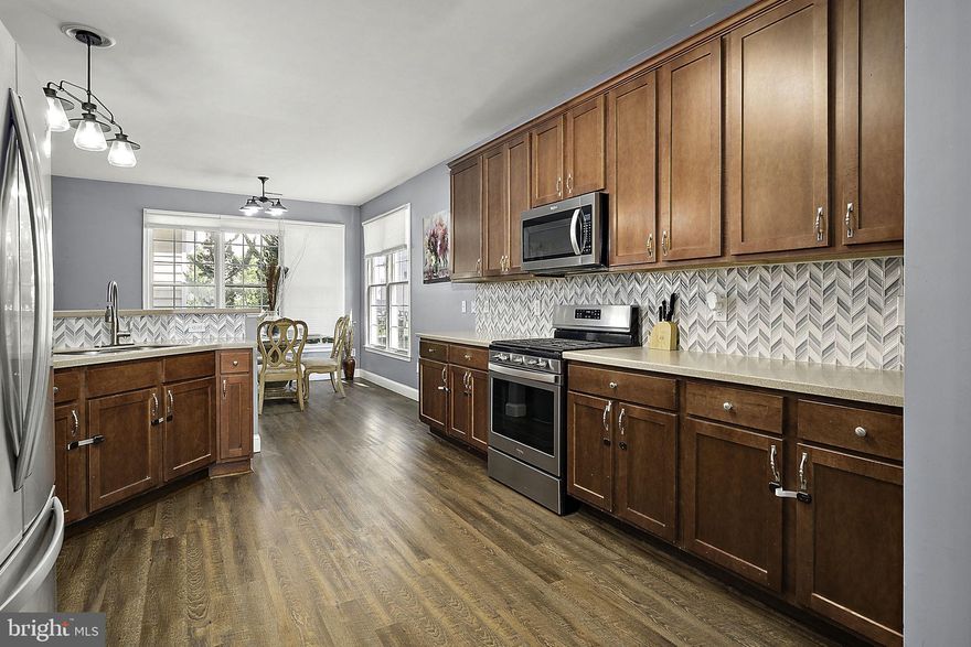 Price Reduction at 12167 Snug Harbour Rd, Berlin, MD – Tucked within the sought-after community of The Landings at Bayside, this beautifully maintained home offers spacious living, resort-style amenities, and unbeatable access to everything the Eastern Shore has to offer. A welcoming front porch with a cozy sitting area sets the tone, while the rear yard features a private patio—perfect for grilling and outdoor entertaining. Inside, the first floor boasts a formal living room and dining room, an open-concept kitchen with breakfast area, a family room with fireplace, and a convenient guest half bath. The second level includes a luxurious primary suite with soaking tub, double vanity, separate shower, plus three additional bedrooms—and a full hall bath. The third floor provides a large bonus space ideal for a fifth bedroom, playroom, game room, or guest suite, complete with a full bathroom. Enjoy the convenience of a detached garage and direct access to a community pathway that leads just a short distance to the pool and clubhouse. With low taxes, affordable HOA fees, and short-term rentals allowed, this home is perfect as a primary residence, vacation getaway, or investment property. The Landings at Bayside offers an exceptional lifestyle with indoor and outdoor heated pools, fitness center, game room, tennis and basketball courts, crabbing pier, stocked fishing pond, kayak launch, nature trails, tot playground, and two community docks with breathtaking bay views. Lawn care and trash service are included, making life here as easy as it is enjoyable.