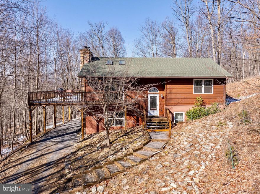 Discover the epitome of mountain living in this fully furnished, exquisite home situated on a private 10.28-acre lot in the serene community of Meadow Hills. Nestled in the sought-after Lost River Valley area, this picturesque residence is conveniently located under 2 hours from Washington, D.C. Step into luxury within this meticulously maintained cabin featuring stunning hardwood floors, an open floor plan, a captivating stone wood-burning fireplace, and a charming wood-burning stove. The interior boasts two full bathrooms, three spacious bedrooms, and ample closet space for all your storage needs. With the added convenience of High-Speed Fiber Optic Internet, this home is not only a tranquil retreat but also an ideal space for remote work. Outside, the property beckons you with a large wrap-around deck, a screened-in porch, a refreshing spring-fed stream, and a private pond, creating an oasis of natural beauty. The home comes equipped with a newly updated HVAC system, water softener system, and top-of-the-line Leaf Filter brand gutter guards. Take full advantage of the abundance of nearby amenities, including lakes for water activities, fishing spots, boating opportunities, and hiking trails for outdoor enthusiasts. In the winter, indulge in skiing adventures. Embrace the local lifestyle with visits to charming shops, organic farmers' markets, and fine dining in nearby Wardensville, WV. Immerse yourself in the vibrant arts scene with local art studios, creating a perfect blend of relaxation and recreation in this idyllic mountain home. Make an appointment today!