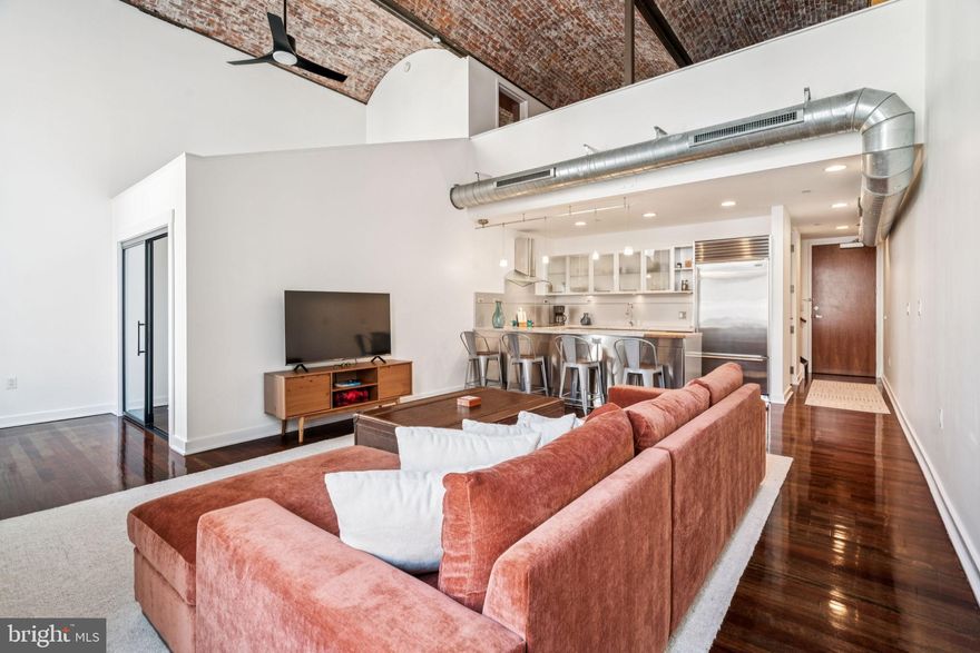 One-of-a-Kind Loft Living in the Heart of Midtown Village Unit 205 | The White Building | Wash West

Welcome to Unit 205 at The White Building, a truly unique, reimagined loft-style residence in the vibrant heart of Midtown Village. This stunning two-bedroom, two-bathroom condo has been completely redesigned with an open-concept layout and thoughtful finishes throughout. Each bedroom features its own private en-suite bath and showcases dramatic views of the soaring, 18-foot original barrel-vaulted ceilings—iconic to this historic building.

Step inside and discover a perfect blend of historic character and modern luxury. Original exposed brick, oversized windows, and expansive white walls create an airy, gallery-like space ideal for art lovers and design enthusiasts alike. With over 1,330 square feet of living space, this loft offers both grandeur and flexibility.

Recent upgrades include: New Casablanca ceiling fans, Sub-Zero refrigerator with new seals and built-in ice maker, New cooktop, new toilets, and fresh interior paint

Enjoy abundant built-in storage and cabinetry, in-unit laundry, secure front door access, an on-site fitness center, mail/package room, and elevator convenience.

The White Building is steeped in history—originally constructed in 1867 as the SS White Dental Manufacturing Company—yet surrounded by exciting modern development, including over $1B in new investment within two blocks. The building's façade restoration is nearly complete, with upgraded hallways and common spaces on the way. Best of all, all current assessments will be paid by the seller at closing.

Step outside to some of Philadelphia’s best dining and nightlife: El Vez, Sampan, Barbuzzo, Charlie Was A Sinner, Lolita, Little Nonna’s, Alpin Rose, Fergie’s Pub, and more—just downstairs.