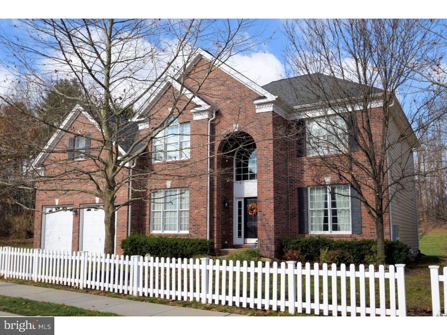 Gorgeous 4 bedroom, 3.5 bath brick front colonial situated on a premium lot on a private cul de sac backing to woods in the community of Overlook at Newtown and within walking distance to Newtown Borough. Enter to a dramatic 2 story foyer with beautiful palladium window above entry, hardwood flooring and turned staircase. Double doors lead to the 1st floor Study, adjacent, a powder room and laundry/mud room. The Formal living and dining rooms feature custom moldings and plush carpeting, perfect for Holiday Entertaining.  Spacious Gourmet kitchen with hardwood flooring, custom raised panel cherry cabinetry, granite countertops, large center island/breakfast bar, GE Profile gas cooktop, double wall oven, GE dishwasher, Stainless steel sink and a half with beautiful triple window above overlooking rear yard. Adjacent is the sun drenched breakfast room with atrium door to custom decking. The 2 story family room features a convenient back staircase, plush carpeting, gas fireplace with marble surround and a wall of windows allowing for plenty of natural sunlight. Above are 4 bright and airy bedrooms including a Master Suite with sitting area and luxurious bath. This home is full of custom upgrades and amenities including a back up generator, both kitchen and breakfast room were constructed with bump out for additional living space,  full finished walk up basement with full bath, custom decking, 2 car garage and professionally manicured gardens.