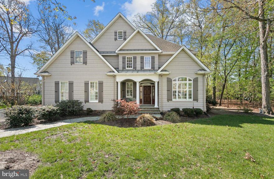 This exceptional custom-built residence offers a refined blend of luxury, privacy, and coastal sophistication. Nestled on an expansive, tree-lined lot with extensive privacy being adjacent to open space, and ample space to accommodate a pool. The setting is both serene and exclusive in this sought after Rehoboth community known as Canal Corkran. Inside, rich Brazilian cherry floors set the tone for elegance, while sleek architectural lines, distinctive vaulted ceilings, and grand entryways create a striking first impression. Walls of windows bathe the home in natural light, enhancing the open, airy ambiance throughout. The first floor is thoughtfully designed for both everyday living and elevated entertaining. A private home office for today’s work-from-home lifestyle sits at the front of the home with vaulted ceilings and French doors for added privacy! The living room is truly breathtaking, boasting soaring ceilings, a stunning stone fireplace, and multiple French doors that open to a tranquil screened porch—an essential feature for enjoying Delaware’s coastal lifestyle in comfort. At the heart of the home, the gourmet kitchen is a chef’s dream with professional-grade appliances, including a Wolf range and Sub-Zero refrigerator, granite countertops, a spacious prep island, and a sunlit eat-in area overlooking the lush, private backyard. Just off the kitchen, the formal dining room provides an elegant setting for more intimate gatherings and special occasions. The first-floor primary suite is a true sanctuary, featuring dual custom walk-in closets and a spa-inspired ensuite bath with dual vanities, a beautifully tiled shower, and an oversized soaking tub—perfect for unwinding in comfort and style. The second level continues to impress, offering three generously sized bedrooms, each with its own private bath, along with a versatile recreation room. A large walk-in closet within this space has been thoughtfully converted into a private office and could easily function as a 5th bedroom, providing flexibility to suit your needs. Storage is abundant and well-appointed, including an oversized two-car garage, a laundry room with additional storage, ample closet space throughout, and a floored attic. Located in a quiet, tucked-away community that offers both privacy and convenience, residents enjoy access to a community pool, the scenic Breakwater Junction Bike Trail, and a peaceful, tree-filled setting. This is a rare opportunity to own a truly distinguished home—schedule your private showing today.