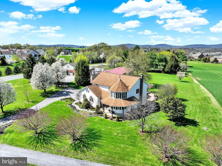 Live, work, and create—home, business space, and garages all in one property.
From the moment you arrive, a sense of presence and possibility is undeniable. Thoughtfully positioned and meticulously maintained, this property offers a lifestyle that extends far beyond the walls of the home. Whether you are an entrepreneur, contractor, car enthusiast, or simply someone seeking space and flexibility, this is a property that adapts to your vision and supports the way you want to live.

THE HOME: As you step into the foyer, you are welcomed by a layout designed with both elegance and functionality in mind. Straight ahead, the home naturally draws you into the stunning kitchen—the true centerpiece—while to the right, the formal living room showcases a striking rounded bump-out, creating the perfect setting for a grand Christmas tree, a cozy sitting area, or a refined space to welcome guests.

The formal dining room flows seamlessly into the kitchen, creating an ideal setting for hosting holidays, celebrations, and gatherings of all kinds. Whether it is a large family dinner or an intimate evening with friends, this space was designed to bring people together in comfort and style.

The kitchen features granite countertops, heated tile flooring, and a layout that keeps you connected to everything happening around you. Just beyond, the great room offers a warm and inviting space for everyday living and entertaining, highlighted by soaring cathedral ceilings and a cozy gas fireplace.

The main level also offers exceptional flexibility, with additional living space that can easily serve as a first-floor bedroom, private office, or quiet retreat, along with a full bathroom and a well-positioned laundry area just off the kitchen.

Upstairs, the home continues to impress with four generously sized bedrooms, including a spacious primary suite featuring vaulted ceilings and a private bath designed for relaxation. The finished lower level expands the living experience even further, offering the perfect setting for recreation, entertaining, or additional living space.

THE COMMERCIAL BUILDING: This is where the property truly distinguishes itself.
The brick commercial building, currently home to a long-standing upholstery business, offers approximately 2,700+ square feet of highly versatile space. With its own well, separate septic system, and independent utilities, along with central air, oil heat, and a newer roof, the infrastructure is already in place to support a wide range of business or investment uses.

A full upper-level storage area provides additional flexibility and could easily be transformed into a private office, studio, or dedicated workspace.

Imagine operating your business just steps from your home—eliminating the commute while maintaining a clear separation between work and living. Whether for contracting, automotive, woodworking, retail, or storage, the possibilities here are exceptional.

THE GARAGE & WORKSPACE: Complementing the commercial building is the expansive detached 4-bay garage—an extraordinary feature that elevates this property even further.

With multiple oversized doors designed to accommodate trailers, work vehicles, equipment, and recreational storage, this space is ideally suited for contractors, car enthusiasts, business owners, or anyone in need of substantial, functional workspace.

This is more than a property—it is a lifestyle defined by flexibility, capability, and opportunity. A place where business and home coexist seamlessly, where creativity and productivity thrive, and where comfort and functionality come together effortlessly.

Opportunities of this caliber are rare. For those who recognize the value of space, versatility, and long-term potential, this is a truly exceptional offering.