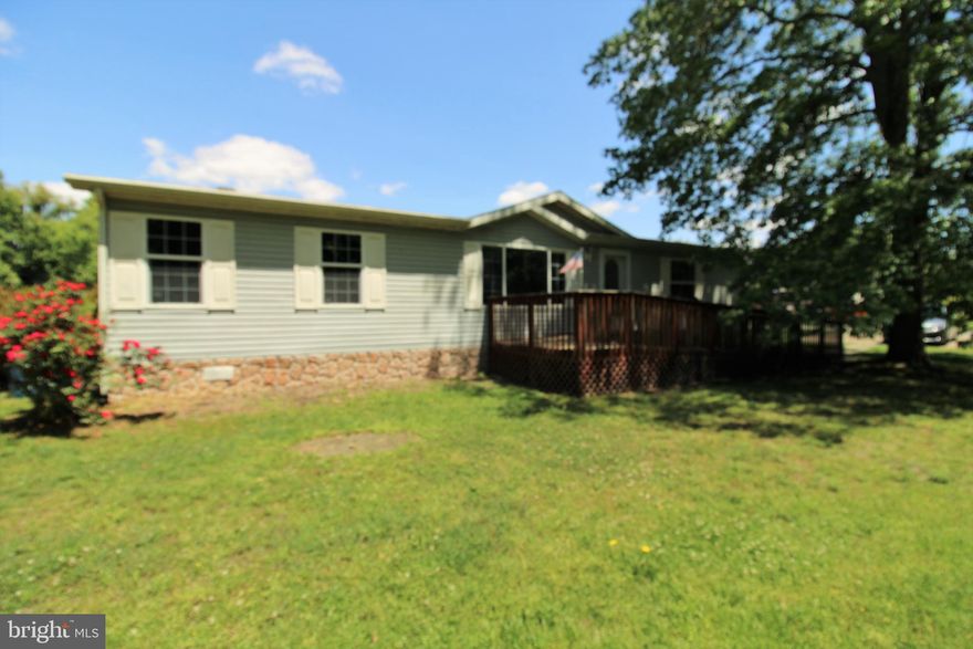 Lot Rental Application is in Documents.  New carpet is being installed throughout so it will be active for viewing soon.   Need possible 4 to 6 weeks for new title. Double wide well taken care of home. Must have park approval prior to writing an offer. Must have proof of funds or approved financing. Lot rent is $310./Month and rent  includes water, sewer, trash pickup, taxes and snow removal of roads only.  Large lot, deck, in back  with sun awning. Paved off street parking. Kitchen has two large sky lights for lots of natural light.  Wonder what to do with your television? Wonder no longer with a large built in area to put TV in out of the way.  Less than a quarter mile to a Dollar General Store. You can have a home inspection, but home is being sold AS IS condition.