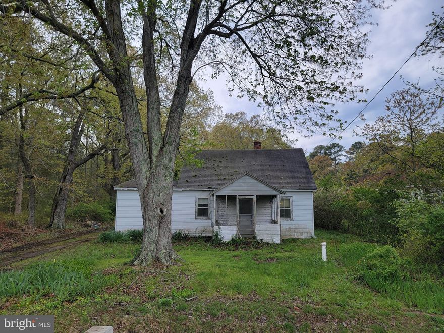 Home is not habitable but has working well and septic as well as electric so perfect opportunity to build your own home or park a trailer/camper.  Located near Point Lookout State park and restaurants.