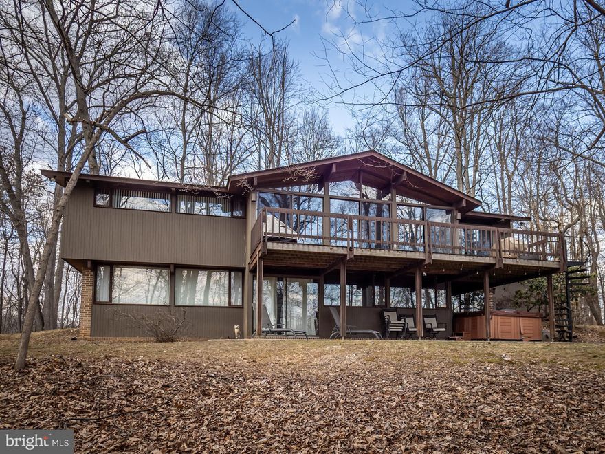 This single family, contemporary style home is located on 2.83 wooded acres. The main level includes a large family room with vaulted ceilings and a brick fireplace, step-down formal dining area, and an airy kitchen with modern cabinets, stainless-steel appliances and premium granite countertops.  A utility room with a full-sized washer and dryer is located off of the kitchen and is adjacent to the garage entrance. The Primary suite is also on the main level. It has cathedral ceilings, tons of closet space, double vanity, separate shower, and large soaking tub. The lower level features a large recreation area, two additional bedrooms, and a full bath. A utility area and separate storage room is also located here. One garage bay is available. The property is on public water and septic.