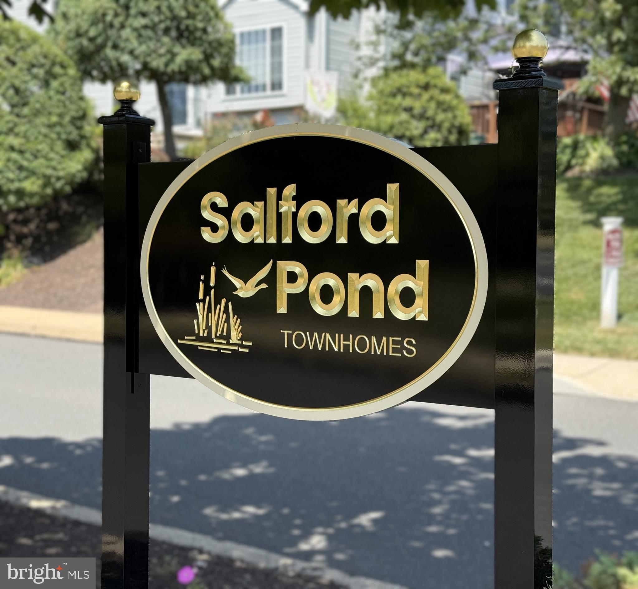 Nestled and Secluded in sought after Salford Pond, Lower Salford Township, this 2-bedroom carriage home is a spectacular find for a discriminating buyer looking to settle into a friendly, quiet, laid-back neighborhood. Open the front entry and welcome to a light filled soaring, two-story great room with plush wall to wall carpeting, ceiling fan and a center showcase piece of a floor to ceiling stone fireplace. The dining room features more plush wall to wall carpeting and a brass chandelier this area is large enough to entertain but could be quite intimate for a candlelit dinner for two. Adjacent find the eat-in kitchen with plenty of oak inset paneled wooden cabinetry, miles of countertop workspace and efficient stainless steel appliances. The back den area is away from the hustle and bustle and provides access to the private outdoor patio where you could enjoy a cup of Joe and your favorite book. Completing the first floor is a convenient half bath and main floor laundry area. Upstairs both bedrooms are large and accommodating with wall to wall carpeting, and large closets, the primary bedroom features a walk-in closet with attic access to a large third level floored attic great for seasonal storage. Both bedrooms on the 2nd floor are serviced by a large hall bath complete with double bowl vanity and separate tub shower, commode accommodations. Parking is never an issue, and you’re just around the corner from Henning’s Market and the Village of Skippack, where you can grab a bite or browse some local shops. Right outside your door, a walking trail connects you to Alderfer Park—with playgrounds, sports fields, and open paths perfect for a morning jog or an evening stroll. Oak Ridge Elementary is just a short distance away, and with the PA Turnpike less than 3 miles down the road, hopping onto I-476 for a quick trip to Philadelphia, King of Prussia, or Malvern is a breeze. Quick settlement is preferred. Don't let this one get away...