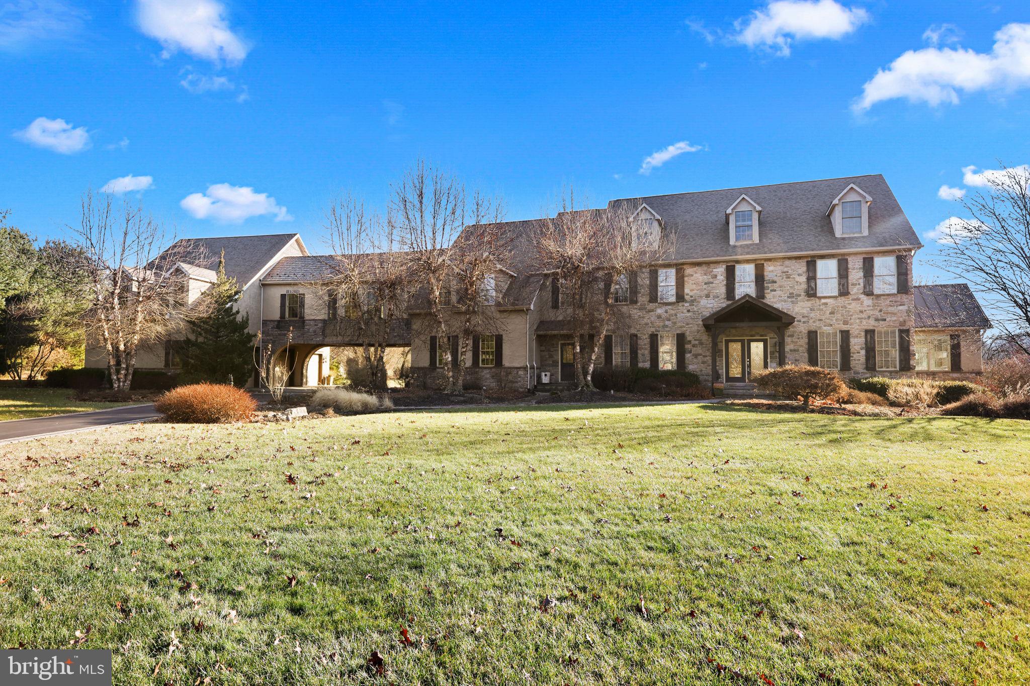 Welcome to 20 Stoudts Ln. This fabulous 5 bedroom, 5.5 bath home sits at the edge of the mountains on 6 acres in a gated community. Drive up to the house through a gated entrance that is secured every evening. The first floor boasts a two story foyer, 19 ft ceilings in the family room with large windows and views of the mountains and fireplace, kitchen with breakfast nook, sunroom, office, dining room, sitting room, powder room, garage access and laundry. The second floor has 4 bedrooms. The primary bedroom including the primary bath and closet is over 1000 sf. A large sitting room and gym complete this suite. The third floor is a massive bedroom with a full bathroom. The lower level is the ultimate entertainment floor. Stone walls encase a full wet bar with fireplace, family room, gameroom, card room, pool room with copper tray ceiling and a 12x11 wine room that holds hundreds of bottles of your finest wine. A full bathroom is available and outdoor access to a fire pit. The amenities of this home are endless: 3 zone HVAC, 6 car garage, heated driveway, breezeway connecting main house to garage, 2 laundry rooms, 2 putting greens, heated in-ground pool, crown molding, sauna, double staircase, cat walk overlooking the family room. The photos speak for themselves; this is a home you must see in person to believe. Call today to schedule!