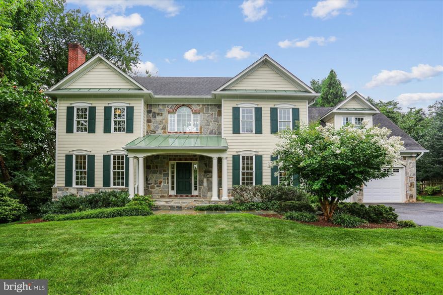 With timeless New England style and thoughtful accents of flagstone and brick, this gracious home sits on an expansive and private park-like lot just blocks from Kensington’s vibrant restaurant scene, boutiques, and amenities.

Inside, elegant architectural details, arched passageways, rich hardwood floors, front-and-back staircases, and two fireplaces, create a warm, inviting atmosphere across four finished levels. The main floor is ideal for entertaining, with generous living and dining rooms, a butler’s pantry, and a chef’s kitchen featuring quartz countertops, an oversized Blanco sink, Viking range, and large island. A stunning family room with a floor-to-ceiling Palladian window frames sweeping views of the private backyard.

Upstairs, the primary suite offers a true retreat with ample space, custom closet systems, and a luxurious bath. Three additional bedrooms each have their own unique character, two share a Jack-and-Jill bath with custom-fitted closets, while the third enjoys its own full bath. The top floor includes a spacious bonus room, full bath, and an additional bedroom, ideal for guests, a studio, or playroom.

The finished lower level includes a recreation room, workroom with pegboard walls, abundant storage, a hydroponic garden, and yet another bedroom and full bath that would also be the perfect home gym.

Outside is a nature lover’s dream: a serene pond, vine-covered pergola, and lush greenspace that backs to untouched land, perfect for four-season enjoyment and alfresco entertaining.

All this, just moments from Baby Cat Brewery, the year-round farmer’s market, Antique Row, and the MARC train. A rare blend of timeless elegance and modern convenience, this home truly offers the best of both worlds.