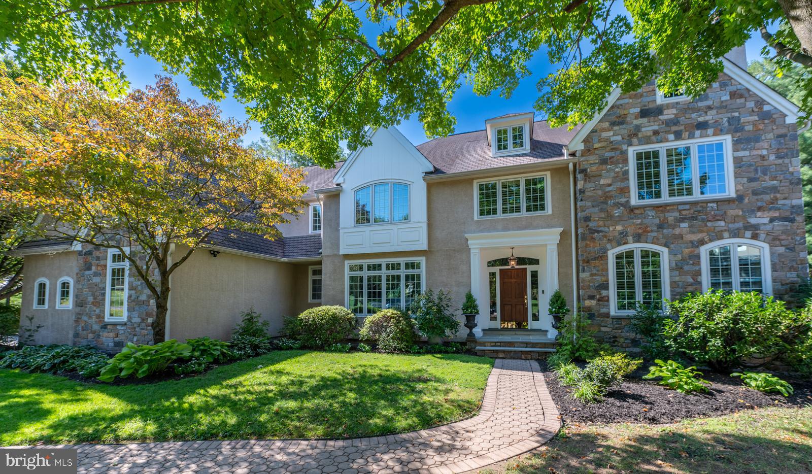 Rare listing in exclusive enclave of Laurier development of 29 well maintained and beautifully landscaped homes in sought after Radnor School District. This pristine French, center hall colonial sits at the end of a cul-de-sac with a premiere 0.80 acre lot that backs up to an additional full acre of maintained private open space with a fenced-in garden and panoramic views. Rows of cryptomerias were added for additional privacy.
The main level has a dramatic marble foyer, Formal Living Room with crown molding, a gas fireplace and Brazilian cherry floors. The Formal Dining Room has a chair rail, crown molding, Brazilian cherry floors and a Butlers Pantry with beverage refrigerator. The completely renovated Gourmet Kitchen features a large island and quartz counters with a gas Viking six burner stove, both gas and electric Viking ovens, Viking convection microwave and Bosch dish washer. French door with transom windows leads to a large renovated deck (2023) with various sitting areas perfect for entertaining or quiet moments. The spacious Family Room with a raised gas fireplace overlooks vistas of the beautiful backyard. The custom cherry paneled study with built in bookcases makes the perfect office for those working at home. In addition, there is a large Laundry Room with cabinets, a Mud Room with access to three car garage, a renovated full Bath with double-vanity sinks and an additional Powder Room.
The second floor features a large Primary Bedroom with His and Her walk In Closets, and a luxurious spa like bath with separated double sinks, large shower and a jacuzzi tub. Bedrooms two and three share a Jack and Jill Bath (renovated with tile floors, double-vanity sinks, custom-lighting). The fourth Bedroom has its own Hall Bath (renovated with tile floors, double vanity sinks, and custom chandelier). Finally, there is a fabulous Bonus/Fifth Bedroom with a sitting area that is currently used as a second floor Family/Study Room. The second floor can be accessed by both the front or back stairways.
The Lower Walk Out Level is perfect for family gatherings or entertaining. A Family Room with a custom chandelier perfect for game night is accented by space for a pool/air hockey table with access to an outside patio through three paneled French doors. The lower level is equipped with a wine refrigerator, Home Theater, a sixth Bedroom with a full Bath, and an additional Bonus Room and raw Storage area. Family Room is plumbed for a kitchen with hot and cold water access.
The home also includes multiple designer chandeliers, plantation shutters, stereo system, and a security system. Stucco has been remediated and all windows were replaced. Stone was added to the front elevation along with all new exterior lighting further adding to this home's charming appeal.
Conveniently located 5 minutes to Bryn Mawr train station, 10 minutes to Ardmore Amtrak, 15 minutes to Suburban Square, and 25 minutes to Philadelphia International Airport.