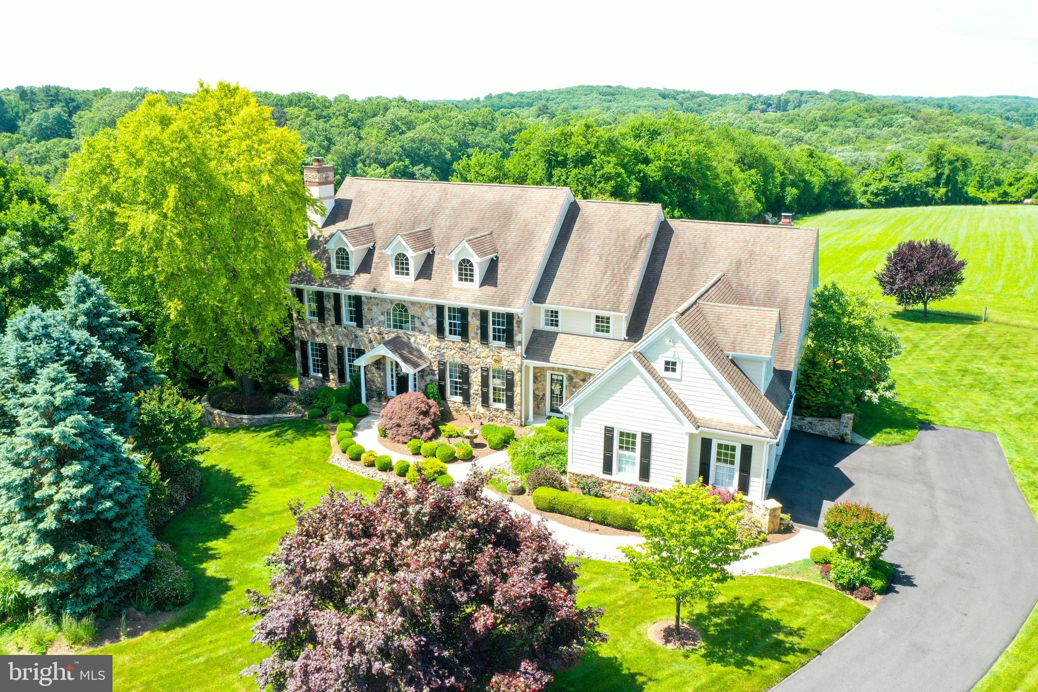 Exquisite 5-bedroom, 5.2 baths Estate home set back in a cul de sac & on an Amazing lot backing to 60 plus acres that are deed restricted and under act 319 in the Unionville Chadds Ford school district. Designed, updated and meticulously maintained all with New Hardie Plank EXTERIOR & New Windows, located in Birmingham Township & is conveniently located in Longview at Wylie. This gracious floor plan will not disappoint! 1st Floor offers an open floor plan with newly finished hardwood flooring, moldings, curved cased doorways & wainscoting. The Formal front to back foyer offers rear access to the New Trex deck and the private office with moldings, and side French door to Trex deck. The formal Living Room with gas burning fireplace, moldings and access to wet bar for all your entertaining and formal powder room! Formal Dining Room with expanded windows & custom moldings. This Open Gourmet Kitchen provides a well thought out space designed for entertaining, offers Stainless Steel Decor appliances, 6-burner Wolf gas range, Subzero refrigerator, granite counters, custom 2-toned Wood Mode cabinets, upgraded lighting, all open to large Breakfast Room with French door to rear deck, and 2nd staircase to upper level. The Family Room is warm & cozy with stone gas fireplace, custom built-ins, and side door to porch & driveway area. The Mud Room, with a private Laundry Room with built in cabinetry and granite counter tops, 2nd powder room, extra closets, Large walk-in Pantry & access to the garage! The Formal stairs take you to the Private Master Suite that offers a master sitting room with custom built-ins, 2- walk-in closets, and an updated AMAZING SPA bathroom with 3-side glass shower, soaking tub, custom his-her cabinetry & lighting all designed for a stunning master bathroom all with views that will wow you! Four additional bedrooms, generous sized closets with Private Bathrooms and 2 share a Jack/Jill bathroom. Access to 3rd floor for extra storage or room to finish. All bedrooms easily access the rear stairs to Kitchen & Family Room area. Finished Lower level with full windows and rear French doors to yard. This Lower level offers a 2nd Family room, gym area, Built-in custom Bar and Bathroom. This home offers breathtaking views of the countryside from every window! Enjoy the rear New Trex deck, with rear steps to yard, all backing to open space. Professional Landscape with outdoor lighting. This home will not disappoint! Great access to roadways, shopping airport and More! Award winning Unionville -Chadds Ford School with Pocopson Elementary!