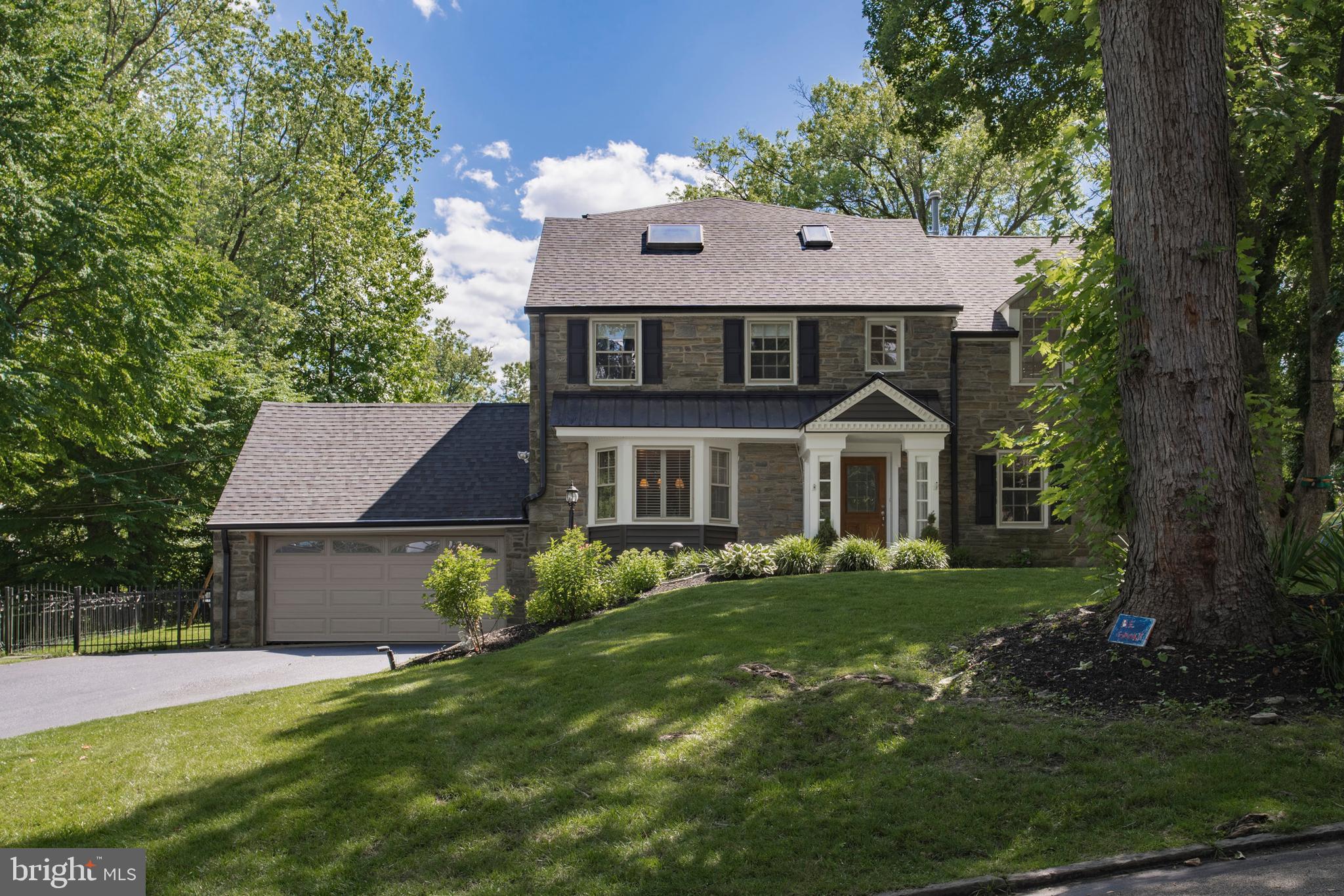 Wonderful opportunity has come to the Main Line Market , located on a beautiful , quiet, tree-lined street in one of Wynnewood's most desirable neighborhoods . This beautiful Stone Colonial is located on a corner lot , it has been updated blending today's modern conveniences with the gracious old world charm. With over 3,800 square feet of wonderful living space plus and additional 1600 square feet off finished lower level and a detached two car garage this home offers a seamless floor plan that flows throughout . The stone steps pathway and landscaped flower beds lead the way to a charming main entrance. From the moment of entry , you will be welcomed to stunning hardwood floors , chair rail molding and chef's kitchen with an open concept that flows into the family room and has direct access to the deck , play area and a completely fenced in side and backyard. The warm and welcoming Living Room featuring a bay window and lovely window seat has direct access to a charming office/study with floor to ceiling built in bookcases .The Formal Dinning Room has wonderful light to enhanced your dinning experience . The second floor offers an expanded Master Bedroom Suite with great closet space as well as an office area with built -in bookcases, marble bathroom shower and double sinks complement the Master Bath . There are two more beautiful Bedrooms on this floor , additional 2 full Bathrooms and Laundry room. The third floor offers two additional Bedrooms one with vaulted ceilings and a full Bath. A finished Lower Level has built-in cabinets and bookcases as well as a separate room for exercise , storage space and another half bathroom. Situated in the award winning Lower Merion School District and settled in the heart of Wynnewood close to shopping, restaurants, public transportation , parks and Center City. Schedule a showing to come and explore your forever home today!