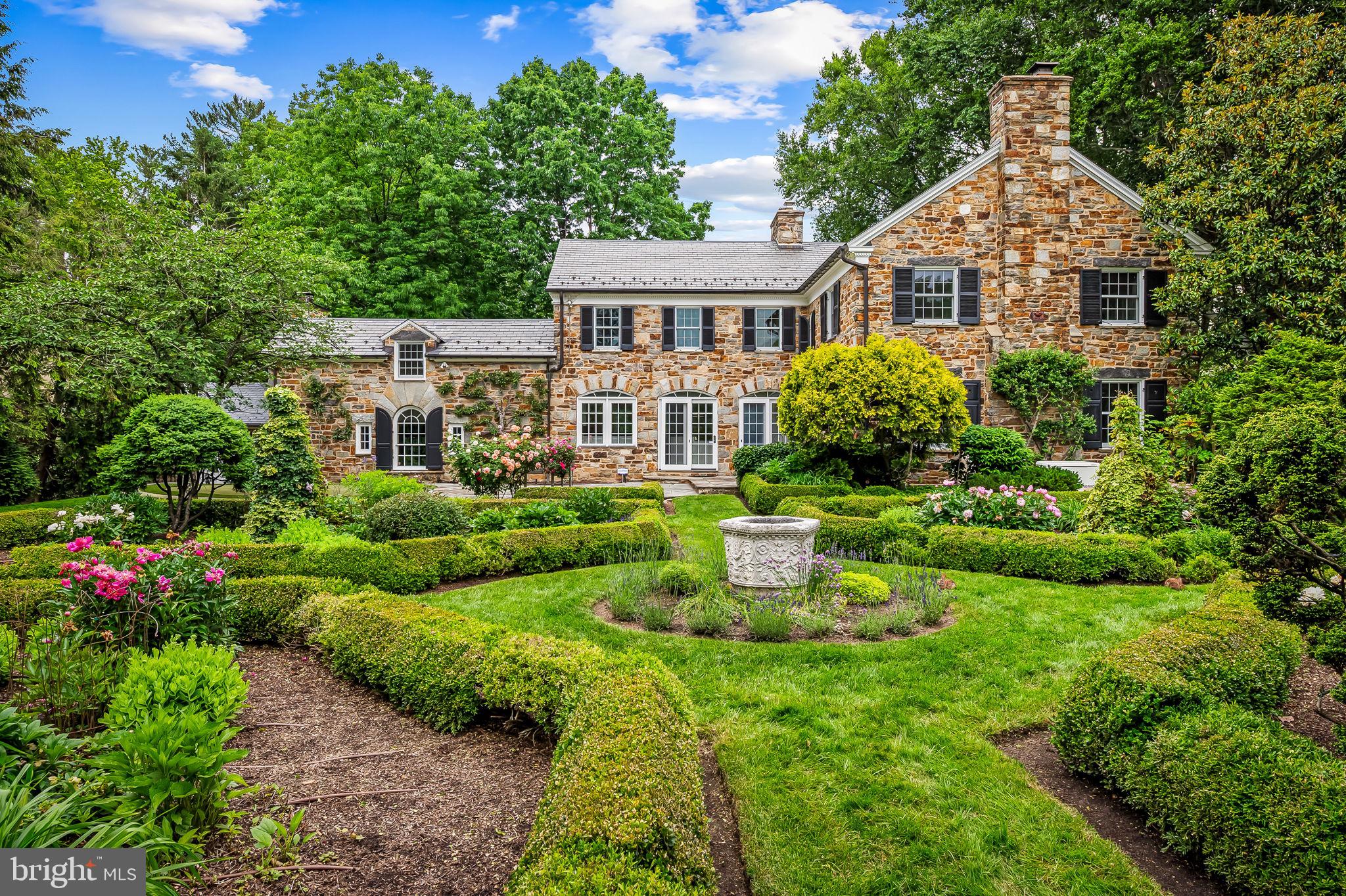 Tucked away in one of Baltimore County’s most treasured and tranquil enclaves, this classic 1937 Butler stone Colonial is a rare offering in the heart of Pinehurst. Perfectly sited on a double lot, the home exudes understated elegance while boasting one of the area's most celebrated "Parterre" gardens—an enchanting landscape of geometric precision and seasonal beauty that once graced the cover of Chesapeake Home magazine. Meticulously maintained and thoughtfully expanded, the home blends historic character with modern comfort. A generous kitchen addition carries through the home’s signature arched details and features expansive views of the gardens and patio. Designed for both everyday living and entertaining, the kitchen includes abundant custom cabinetry, a built-in desk, wet bar, and a spacious butler’s pantry. The adjacent family room is richly appointed with cherry wood built-ins, built-in shutters, a custom designed arched fireplace, and warm architectural detailing throughout. Upstairs, you'll find four bedrooms plus a dedicated home office, and three full baths. A second-floor laundry room adds modern convenience, complemented by an additional laundry area in the basement. The attic is spotless, floored, and ideal for easy storage. The lower level offers a clean, expansive basement with a full bath—perfect for a variety of uses. This is a rare opportunity to own a signature home in one of Baltimore’s most desirable, tightly held neighborhoods—where listings are few and far between, and pride of ownership runs deep. The adjacent lot conveys with the property.