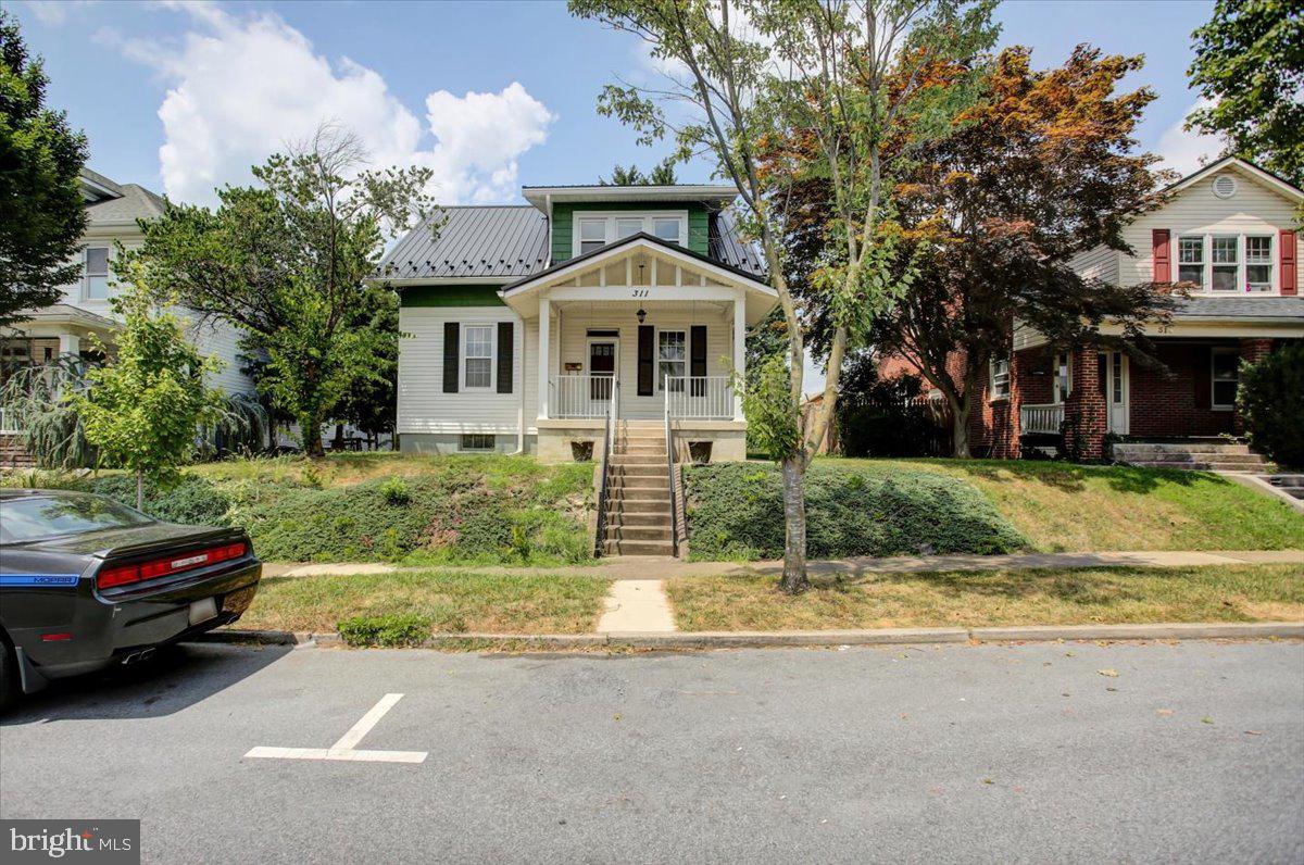 This single family home is full of potential for someone who is looking for a convenient location in a well established neighborhood! A fixer upper that could use updating with loads of potential! You'll be welcomed by the great front porch that is perfect for relaxing & has mailbox right by the door. This home has wall to wall carpet that was just professionally cleaned as well as unique light fixtures. There is access to the stairway on both the front & back side of the home. Livingroom, Dining Room, Kitchen with Pantry, Full Bath and Den/Bonus Room are all on the main level. Upstairs you will find 2 Bedrooms and an attic room that can be used for storage or additional closet space. Cedar lined closet in the Master BR. The full basement is unfinished & already has a Washer & Dryer & Freezer there for your convenience. There is an exit thru Cellar Doors from the basement to the outside. The home is equipped with a Security System that may be activated by the new owner. The rear exit off the kitchen takes you into the partially fenced Backyard. In the back there is a shed and off alley parking for an additional vehicle in the back. Vinyl siding and nice Metal Roof have been added as well. City Water, Sewer & Trash Pick-up. Home is being sold "AS IS".