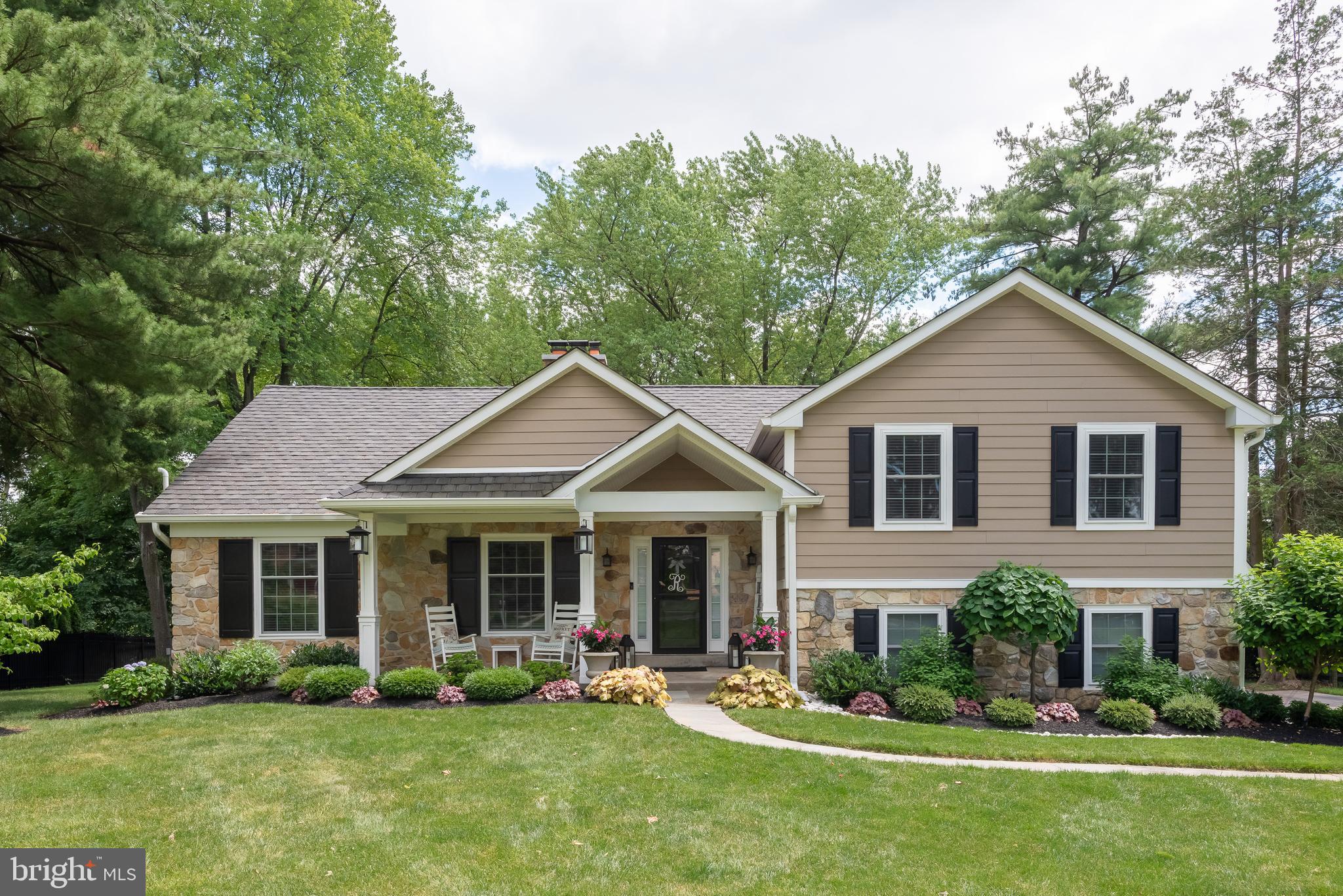 Welcome to 552 Gulph Road, a gorgeously updated home offering FIVE beautifully finished living levels in Glenhardie, one of the most sought after neighborhoods on The Main Line. Situated on a fantastic lot with a wonderful, deep rear yard, this is a terrific property, both inside and out. This exceptional home is just steps from Valley Forge National Park. A rare opportunity to own a fully updated home in a prime neighborhood within the top ranked Tredyffrin-Easttown School District. The covered front porch leads to the spacious living room which features a wood burning fireplace with classic Colonial mantle. The heart of the home is the gourmet kitchen offering a large granite topped center island with pendant lighting, plenty of cabinet space, under cabinet lighting, granite countertops with a subway tile backsplash, a double stainless steel sink, stainless steel appliances, a pantry and a wall of exposed brick with a second wood burning fireplace. An open concept dining area off the kitchen offers a sliding glass door opening to a huge, low maintenance deck overlooking the rear yard. The second level is home to the owner's suite which features two double closets and a sumptuous owner's bathroom with a soft finished granite vanity with twin sinks, tile flooring and a huge shower with river rock flooring and walls plus a seamless glass door. Two additional bedrooms, each with double closets, are serviced by a beautifully renovated hall bathroom with a quartz topped vanity and subway tiled shower. The third floor loft/bedroom suite also has a double closet and is serviced by its own bathroom with updated marble vanity and tile shower floors and shower with a seamless glass entry. The lower level family room is a terrific finished space offering a custom wet bar with wine rack and beverage refrigerator, a powder room plus double sliding glass doors to the walkout patio area. A mudroom with built in seating bench and cubbies, coat hooks and a double closet leads to both the side driveway and the two car garage. The laundry area is perfectly situated on this level. Unlike the vast majority of the homes of this style, 552 Gulph Road has a fully finished basement area along with a huge unfinished storage room. The spectacular lot offers mature plantings, professionally landscaped front and rear garden beds and plenty of yard space to play, and is equipped with an electric fence around the front and rear yards. The deck is the ideal spot for entertaining, grilling and dining al fresco. A gorgeous stone patio with a built-in natural gas firepit is perfect for late night relaxing and conversation. Note that the patio is pre-wired for a hot tub, if so desired. Hardwood flooring, recessed lighting, tremendous closet, attic and storage space, ceiling fans in all four bedrooms, nice millwork, multiple outdoor living areas, an open concept floor plan, tasteful color choices and so much more all come together to make 552 Gulph Road a very, very special place to call home. Watch the four seasons unfold from every window in this beautiful area near historic Valley Forge Park. Close to Trader Joes, Wegmans, the King of Prussia Town Center and the shops, restaurants, and trains of the Main Line. Truly a once in a lifetime opportunity. This is the one. Welcome home!