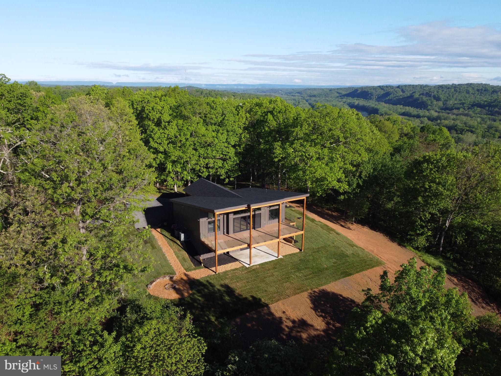 Wake up every day to stunning, uninterrupted views of the Potomac River and Licking Creek from your own expansive composite deck—spanning the full length of this brand-new, modern home. Whether you're sipping coffee in the morning or enjoying a glass of wine at sunset, the view is a showstopper.
Inside, you'll find classic hardwood floors, ceramic tile, and recessed lighting throughout. The main level offers two luxurious bathrooms with upscale finishes, and a cozy gas fireplace perfect for cool evenings. The kitchen is equipped with Café-brand appliances, quartz countertops, upgraded cabinetry, and stylish accent walls that give the home a clean, timeless look.
Downstairs, the lower level has its own full GE appliance package, flexible space for two to three bedrooms or a home office, and a walk-out patio wired for a hot tub and a gas line ready for your firepit. It's ideal for entertaining, guests, or just relaxing in comfort.
This property isn’t just a house—it’s an experience. From the deck, enjoy the rare combination of watching planes, trains, boats, and cars go by—all from one spot. It's like having your own private overlook.
Be sure to check out the Matterport tour and floor plan, but most importantly—schedule a visit. Photos can’t do the view justice. You have to see it for yourself. 3,440 total finished square feet of craftsmanship.
This is your chance to own a high-end home with million-dollar views at a smart price. Don’t let it slip away.