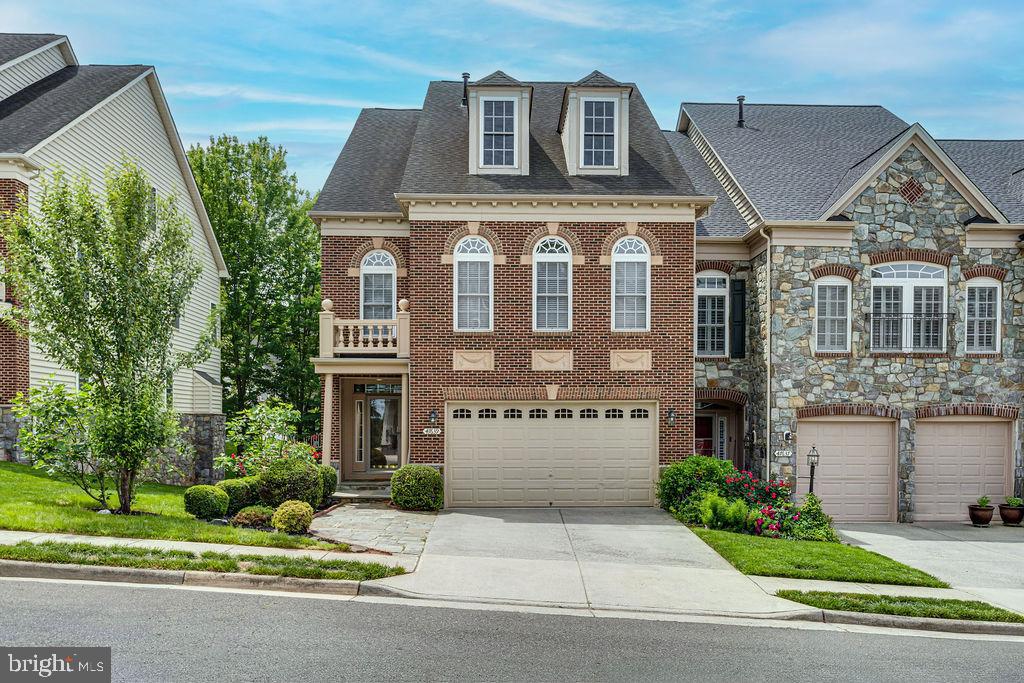 Discover this rarely available end-unit townhome, a masterpiece by NV Homes, offering over 4,300 sq/ft across four levels. This 4-bedroom, 4½-bathroom residence is bathed in natural light throughout, blending sophisticated elegance with modern comfort.
The grand entrance reveals gleaming hardwood floors on the main level, leading to an expansive, open floor plan. Cozy up by one of two beautifully appointed fireplaces, each framed by bespoke built-in bookshelves.
The entertainer’s dream kitchen boasts a gourmet kitchen with stainless steel appliances, a vast granite countertop island, and abundant custom cabinetry and pantry space. The kitchen seamlessly opens onto a private deck, perfect for al fresco dining. An oversized walk-in laundry room with a folding station, sink, and ample storage adds convenience.
Ascend to the spacious master bedroom suite, a true oasis. Indulge in the spa-like ensuite master bathroom, designed for ultimate relaxation, and begin your day on your private master balcony.
The fully finished, walk-out lower level is an entertainer's paradise, featuring a stylish full bar and an additional full bathroom – ideal for gatherings or a private suite.
Prime Location & Lifestyle: Centrally located in Lowes Island, this home offers direct access to community amenities, pristine walking trails, and the renowned Trump National Golf Club. Enjoy unparalleled proximity to the Potomac River for recreation. Major shopping and dining destinations like One Loudoun, Dulles Town Center, Cascades Overlook, Leesburg Premium Outlets, and Reston Town Center are a short distance away. Commuting is effortless with easy access to Rt. 7, Rt. 28, and Fairfax County Parkway.
This luxurious, turn-key home in a vibrant community with exceptional amenities and an unbeatable location is an unparalleled opportunity. Welcome home!