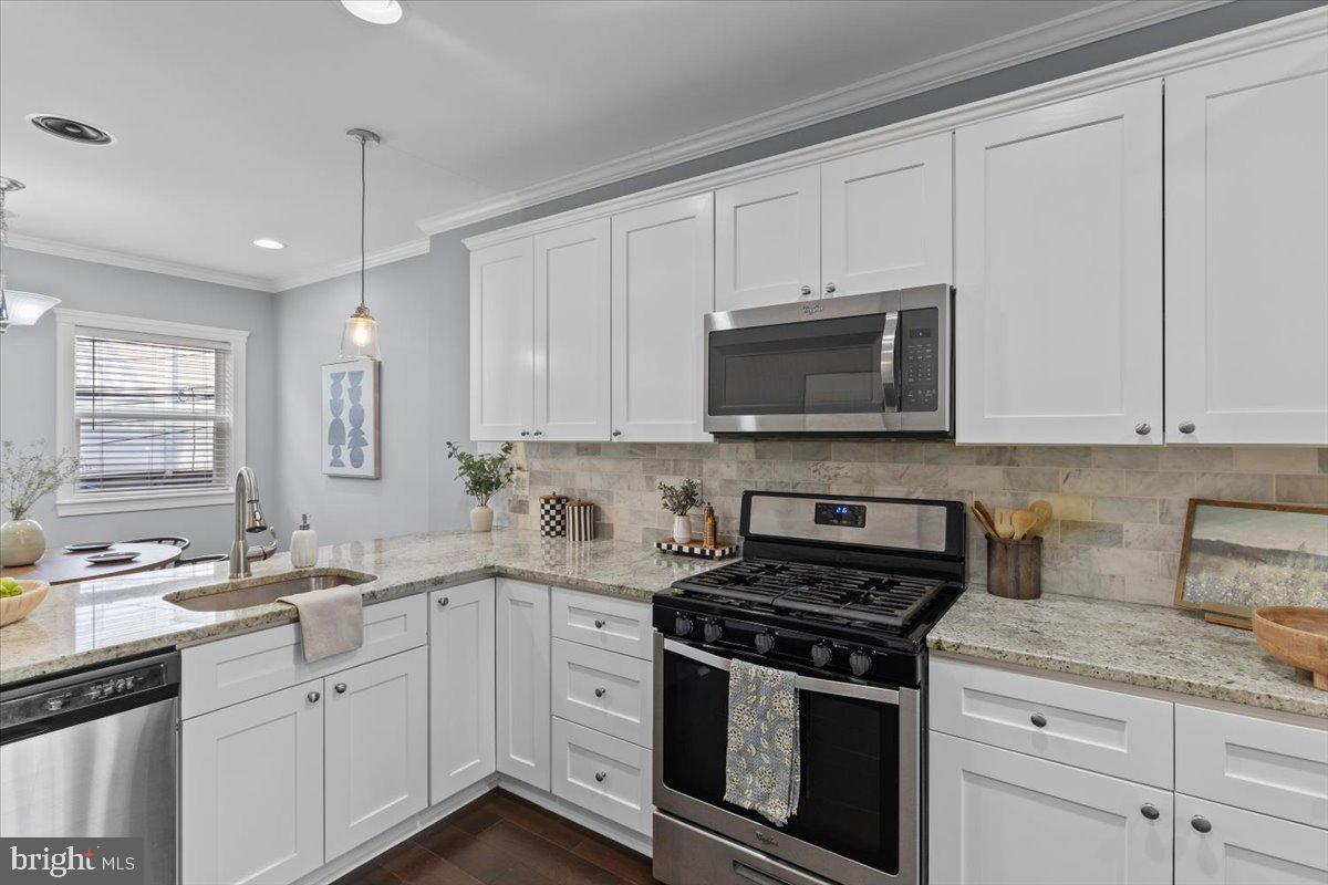 Stunning renovated brick rowhome in the heart of Federal Hill, showcasing high end finishes throughout. This beautifully updated home features exposed brick walls, recessed lighting, crown molding, and gleaming hardwood floors. The gourmet kitchen is a chef’s dream with granite countertops, stainless steel appliances, and a spacious dining area. Upstairs, the primary suite offers a luxurious spa like bath, along with a second bedroom and full bath. The finished lower level includes two additional bedrooms and a full bath, perfect for guests or a home office setup. Enjoy water views from the rooftop deck, ideal for relaxing or entertaining. A true gem in a prime location!