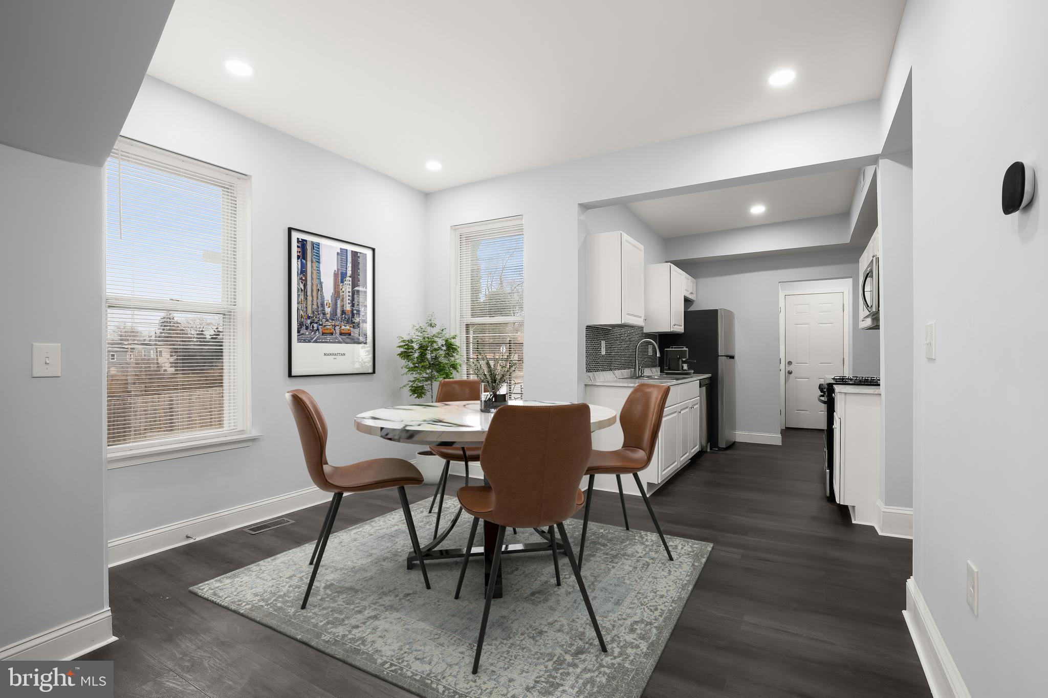 Welcome home to this thoughtfully, just renovated 3-bedroom, 1.5 bath end-of-group rowhome, offering modern updates and stylish finishes throughout. Step inside to an open and airy main level, where the living and dining areas flow seamlessly into the sleek, updated kitchen. Freshly painted walls and new luxury vinyl plank flooring add a contemporary touch, while the convenient main-level powder room enhances everyday functionality. The kitchen, both stylish and efficient, boasts crisp white cabinetry, brand-new stainless steel appliances, a gas range, and a decorative backsplash. A rear door leads to the covered porch and a private, fenced corner lot—perfect for outdoor relaxation. Upstairs, you'll find three comfortable bedrooms, all with plush new carpeting, and a refreshed hall bath featuring modern shower fixtures. The lower level offers additional flexible space, including a bonus room ideal for a home office, guest suite, or hobby room. Located close to public transportation and major commuter routes, this home combines convenience with contemporary charm. Don’t miss your chance to make it yours—whether you're looking for your next investment property or searching for the perfect place to call home! Note: Select interior photos have been virtually staged *Seller is highly motivated*