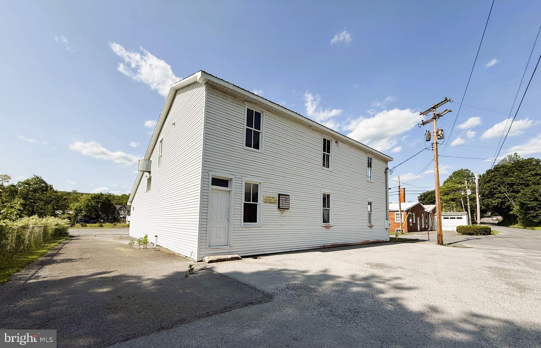 This prime opportunity offers investors and entrepreneurs a flexible space with exceptional possibilities. The solid, partially open-concept space provides maximum adaptability for a wide range of commercial uses including village oriented shops, eating and drinking establishments, studios for the instruction in performing arts, photo/artist studios, live work quarters, or a Hostel, other manufacturing uses may be permissible. The spacious main floor features ample work area with high ceilings and an open layout that can be configured to meet your specific business needs. A convenient roll-up door ensures easy access for materials, equipment, and vehicles, while dedicated parking and loading bay facilities streamline operations.
The second floor presents an exciting opportunity for creative buyers, and while requiring renovation work, this space offers tremendous potential for conversion into a residential apartment unit, additional office space, storage areas, or mixed-use development. The property features solid construction with an adaptable open floor plan, roll-up door for convenient material and equipment access, loading bay for efficient operations, , dedicated parking area and that upper level with conversion potential, making it ideal for owner-operators or investment opportunities.
The property is sold AS-IS. Square footage is estimated so buyers must verify all measurements and room dimensions. This unique property combines immediate commercial functionality with long-term development potential, making it an exceptional value for buyers with vision and renovation experience. Schedule your showing today to explore the possibilities this versatile space has to offer.