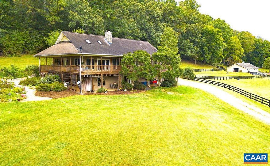 Price Improvement!  The peaceful & captivating 21.08 acres is .4 of a mile off Route 151 in the heart of a sought-after area & highly desired community in Nelson Co. The 3,550 sq. ft. 4-bedroom/3.5 bath home & barns are situated for optimal privacy, security, & ease of use. The quality-built home is open concept w/ living room, dining rm, & kitchen flowing together. Highlights of the main floor are the hardwood floors, gorgeous floor-to-ceiling stone fireplace, & many windows & glass doors allowing natural light & magnificent pastoral & mountain views. An extension of the main floor is the stately & spacious wrap around covered porch w/recessed lighting providing a yr.-round place to enjoy family, friends, & nature. The primary ensuite on the main features a walk-in closet, dual vanities, tile floor, mountain and pastoral views. 2 oversized bedrooms on the main boast large closets & are adjoined by a jack-n-jill ensuite w/dual vanity & tile flooring. Terrace level offers a private entry off of a 10x70 stone paved covered patio, a large laundry rm, office area, & massive ensuite perfect for multigeneration or guest rm. Backup generator.,Formica Counter,Granite Counter,Wood Cabinets,Fireplace in Living Room