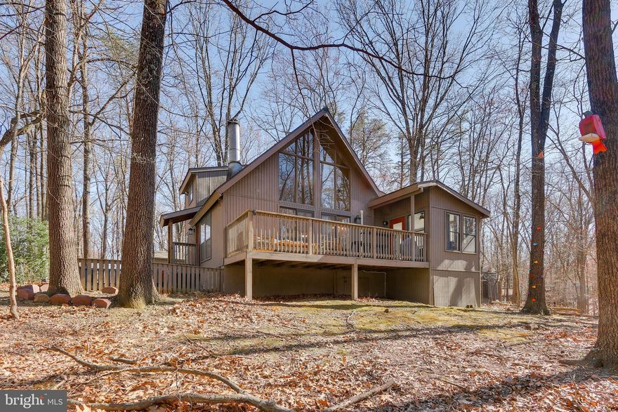 Find your peaceful retreat in this charming 2-bedroom, 2-bathroom home, set on a spacious one-acre lot in a quiet neighborhood. As you walk in, you'll be welcomed by plenty of natural light that brightens up the cozy living spaces, all tied together with an open layout. The indoor fireplace is perfect for adding warmth and a cozy vibe on chilly nights. Step outside to a lovely fire pit that’s perfect for gathering with friends under the stars. The versatile sunroom gives you the chance to make the space your own and opens up to a wooden deck with stunning views of the surrounding forest—ideal for outdoor meals or just soaking in the morning calm. There’s also a small fenced yard that’s great for your furry friends, plus a handy shed for extra storage. This home blends comfort and style with the beauty of nature, offering a laid-back lifestyle. Come and see the magic of this special property, and start imagining all the great memories waiting for you in your own little haven!