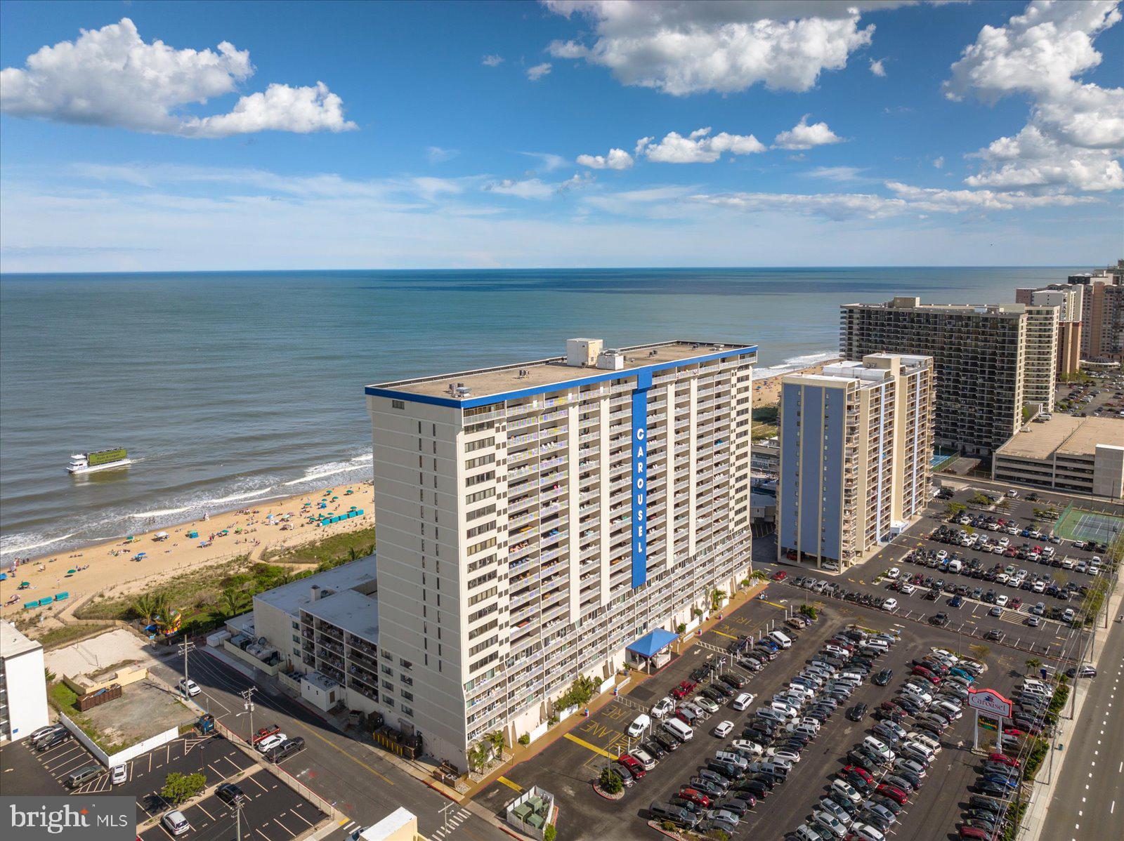 The ideal oceanfront condo has finally hit the market! This two-bedroom, two-bath condo boasts impeccable ocean views as soon as you step through the front door, not to mention fantastic bay views from your front door and front balcony. Step inside to find tile floors throughout, a coastal white kitchen with granite countertops, tile backsplash, and stainless steel appliances, a dining area just off the kitchen, and a spacious family room overlooking the ocean. The oversized balcony offers panoramic views of the ocean and beach and plenty of space to entertain. The balcony also comes with hurricane shutters, giving added piece of mind and helping with insurance costs. The roomy master suite boasts an en-suite bath and easy access to the laundry room, and the second bedroom offers plenty of space for guests and has access to a full guest bathroom. This is one of very few condos in Ocean City that offers both an oceanfront balcony as well as a bayfront balcony, giving you twice the outdoor space to enjoy, as well as a private closet for beach toys. The Carousel building is a vacation destination in itself offering an impressive amenities package, to include indoor and outdoor pools, the only ice skating rink in Ocean City, two restaurants, a gift shop, a coffee shop, a fitness center, a game room, a tot-lot, and so much more! If you're looking for a private beach retreat, this condo has everything you need to maximize your fun in the sun without even leaving the building, plus you can enjoy all the building has to offer even in the winter months. If you're looking for an investment property, this property is a money-making machine with its location, condition, size, and the Carousel amenities, averaging over $40,000 annually in gross rental income. Scoop this condo up now and be ready for summer 2025!