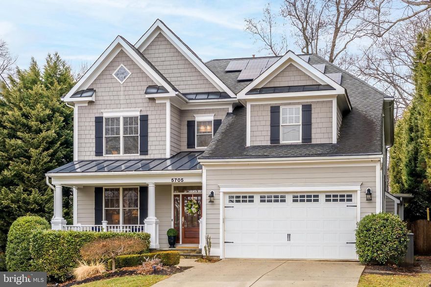 SCREENED IN PORCH * NANO WALL * REAR PATIO * FENCED REAR YARD *  UPDATED KITCHEN & BATHROOM * SOLAR PANELS *  OVER 200K IN UPGRADES 5705 LONE OAK HAS IT ALL --A beautifully appointed home featuring hardwood floors and crown molding throughout the main and upper levels, with wainscoting and board-and-batten detail in the foyer, living, and dining rooms. Decorative columns, a grand staircase with carpet runner and wood railing, and a formal dining room with wallpaper accent set a refined tone. The home office offers built-in floor-to-ceiling shelving behind French doors, while the mudroom delivers built-in cubbies and a butler's pantry/wet bar with wine refrigerator. The open family room centers on a gas fireplace with white mantel and flows into a chef's kitchen with white shaker cabinets, quartz countertops, large island, gas cooktop, double wall ovens, decorative tile backsplash, and under-cabinet lighting — plus a breakfast area with bay window. Upstairs, the primary suite features a tray ceiling, accent wall, and a spa bath with freestanding soaking tub, heated floors, oversized frameless glass shower with rain head and bench, double vanity, and pendant lighting. Three secondary bedrooms, a jack-and-jill bath, an additional full bath, a vaulted bonus room, and a finished basement with rec room, bedroom, and full bath round out the interior.Outside, hardiplank siding, a covered front porch with columns and railing, and a metal porch roof deliver strong curb appeal, while solar panels and a Level 2 EV charger speak to modern efficiency. The backyard is built for every season — a screened porch addition with four skylights, beadboard ceiling, recessed lighting, and a Nana tri-fold wall opening to the family room transitions to a flagstone patio, raised stone fire pit with seating wall, hot tub, and a large flat, privacy-fenced yard with mature landscaping.Lone Oak offers a superior location with easy access to major commuter roads, is a short walk to Wildwood Shopping Center, and is also just minutes to Downtown Bethesda.