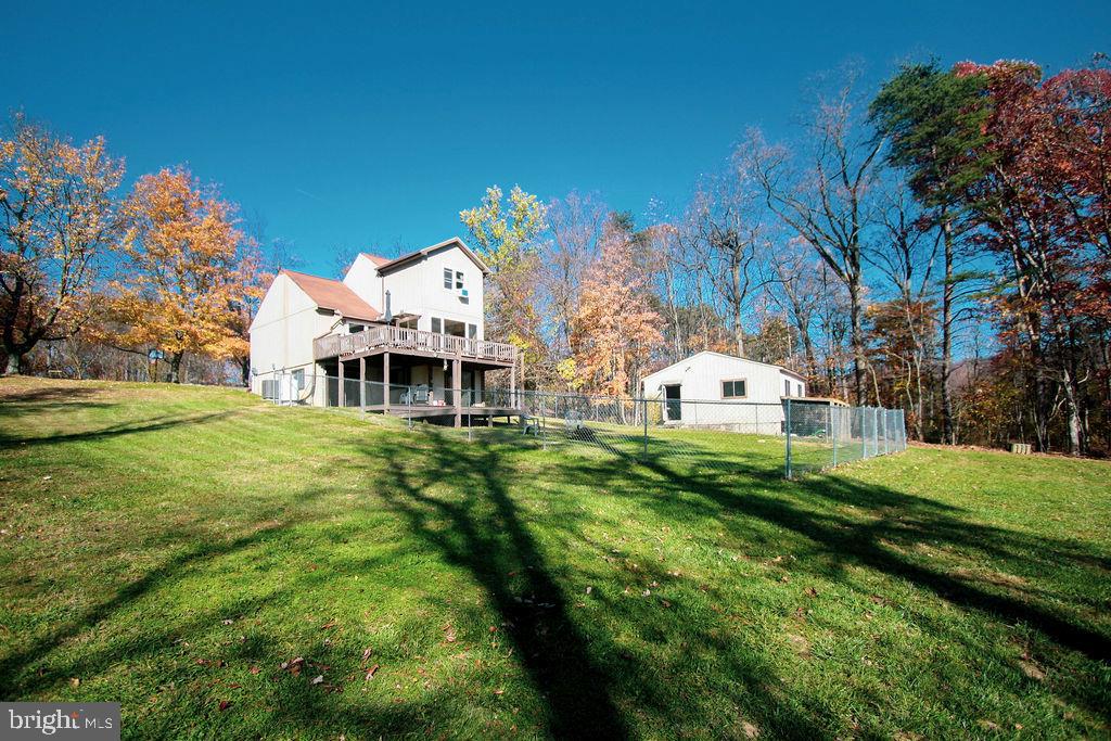 Enjoy the scenery and wildlife from the large windows or the two tiered deck with a sunny southern exposure. Great yard, partially fenced with circular pathed drive way for easy access. Beautiful, bright and open floor plan with vaulted ceiling and a propane fireplace for those cozy evenings. Fully finished walk-out lower level boasts a large family room, full bath, separate laundry area and a workout fitness room. New Heat Pump in 2017, new windows in 2019, and new roof being installed Nov 2020. Detached 24'x24' workshop with electric. Sought after private development with paved roads, underground utilities with easy access to I81 Inwood exit. Cable and cellular services all situated on 1.58 gently sloping lot.