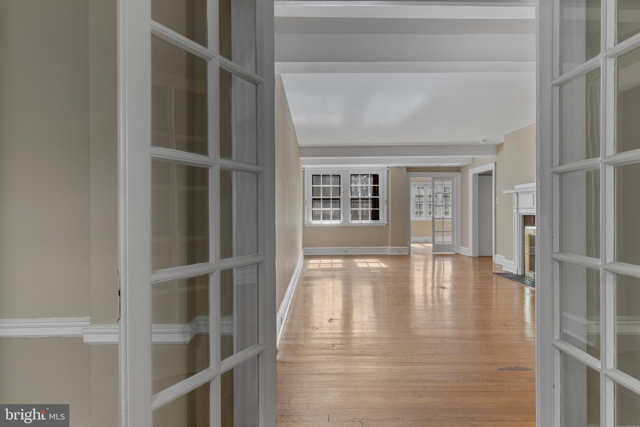 Welcome to this beautifully updated 2 bedroom, 2 full bath residence in the historic Yorklynne Manor. Offering 1,880 sq. ft. of living space, this home is one of the largest units in the community and is ideally positioned toward the back of the building, providing peaceful views and a serene setting.Step inside to discover a gracious, oversized living room with a cozy fireplace, a large formal dining room perfect for entertaining, and a renovated kitchen with breakfast room, complete with updated finishes and direct access to a charming balcony. A separate laundry area is conveniently located just off the kitchen.The entry foyer opens to a light-filled library/guest room with custom built-ins, ideal as a home office or third bedroom. Both bedrooms are generously sized, with the primary suite featuring a walk-in closet and private, updated bath.Throughout the unit, you’ll find gleaming hardwood floors, updated bathrooms, and timeless architectural details. The building itself boasts a unique courtyard with water feature, enhancing the historic charm of this sought-after community.Additional features include a deeded garage parking space, proximity to Saint Joseph’s University, Center City, and all major transportation routes.