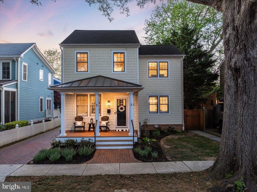Introducing 122 Chesapeake Avenue, a beautifully constructed Eastport residence offering refined coastal living with elevated design throughout. Built in 2014, this luxury Craftsman showcases a seamless blend of clean architectural lines, modern functionality, and high-end finishes across all three levels. The main level is designed for effortless living and entertaining, featuring an open layout with rich hardwood flooring, detailed millwork, coffered ceilings, and a gas fireplace framed by custom built-ins. The kitchen serves as the centerpiece of the home with a substantial island, professional-grade gas range, walk-in pantry, and a well-appointed butler’s pantry complete with a wet bar and beverage cooler. Indoor and outdoor living connect seamlessly with access to a spacious screened porch, patio, and fully fenced yard. A flexible main-level office with an adjacent full bath offers the option for a guest suite or fifth bedroom. Upstairs, the primary suite is both bright and inviting, featuring vaulted ceilings, a gas fireplace, dual walk-in closets, and a spa-inspired bath with a freestanding soaking tub and double vanity. Two additional bedrooms each include private en-suite baths, along with a conveniently located upper-level laundry room. The finished lower level, renovated in 2024, provides a generous secondary living area with a gas fireplace, an additional bedroom and full bath, a separate flex room, and multiple storage areas. Complete with professionally landscaped grounds, hardscaping, a built-in outdoor grill, and private driveway parking, this home is ideally positioned near Eastport’s waterfront, marinas, and just minutes to downtown Annapolis. A turnkey offering combining thoughtful design, comfort, and location.