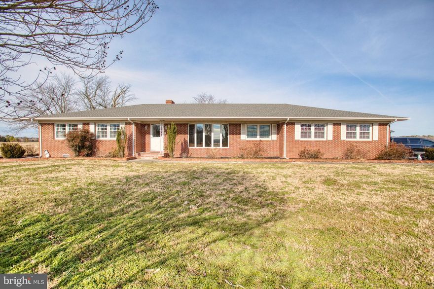 Tucked away on a serene 10.13-acre setting, this beautifully appointed single-level, 4-bedroom, 3-bath home at Agnes Mitchell Lands offers the perfect blend of space, comfort, and Eastern Shore charm.

Step inside to a welcoming living room filled with abundant natural light from oversized bay windows, highlighting custom built-ins and creating an inviting space to relax or entertain. The flow continues seamlessly into the kitchen and dining area, where sunlight pours in and a cozy fireplace anchors the room—ideal for everyday living or hosting memorable gatherings. The kitchen is thoughtfully designed with ample cabinetry, a center island, and comes fully equipped, offering both functionality and style. Sliding access to the backyard makes indoor-outdoor living effortless.

All bedrooms are generously sized, providing flexibility for family, guests, or a home office. The primary suite is a true retreat, complete with its own private bath for added comfort and privacy. With everything on one floor, the home delivers ease of living without sacrificing space.

Outside, the expansive acreage opens up endless possibilities—gardening, recreation, or simply enjoying the peaceful surroundings. A pole barn adds exceptional value, perfect for storage, hobbies, equipment, or future projects.

Located in a desirable pocket of the Eastern Shore, the property enjoys convenient access to a variety of nearby amenities while still offering a peaceful, rural lifestyle. Just minutes away, Delmar provides everyday conveniences including local shops, restaurants, schools, and community services, while nearby Salisbury offers a broader selection of dining, shopping, healthcare facilities, and entertainment options, as well as Salisbury University. Easy access to Route 13 makes commuting and travel simple, and outdoor enthusiasts will appreciate the proximity to parks, scenic farmland, and recreational areas. Don’t miss this rare opportunity to own a spacious, single-level home on over ten acres in a sought-after setting. Schedule your private showing today and make this exceptional property your own.