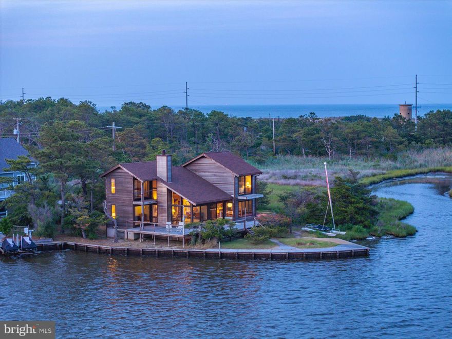 Rare Waterfront Gem in Bethany Beach – A once-in-a-lifetime opportunity to own an exceptional piece of coastal paradise in the highly desirable Bayview Park community. Offered for the first time, this charming single-family home spans two lots, providing unparalleled panoramic bay views with the Ocean City and Fenwick Island skylines in the distance. Nestled amidst protected lands, this property combines privacy with proximity to the beach—just a short walk away. Enjoy breathtaking sunsets, stargazing under the moonlight, and the serene sounds of the bay. Whether you're seeking relaxation or adventure, this home offers the best of both worlds. Designed for coastal living, the home boasts expansive casement windows and glass sliders that invite the sea breeze and natural light into every room. The main level features a cozy family room with a wood-burning fireplace, a dining area with sweeping water views, and a bright kitchen perfect for entertaining. A spacious bedroom and full bathroom on this level overlook the bay, offering the perfect retreat after a day at the beach. Step outside to an expansive waterfront deck, ideal for enjoying sunset dinners, crab feasts, or simply unwinding with a cold drink while soaking in the tranquil surroundings. Upstairs, you’ll find a private primary bedroom suite with stunning water views and its own deck, plus an additional bayfront bedroom with a full bath—each offering a peaceful retreat with unmatched vistas. This unique property presents endless possibilities. Keep the home as it is and preserve its coastal charm or renovate to fit your vision. Alternatively, with two lots included, build a custom dream home or even potentially two single-family homes to fully capitalize on this exceptional location. Boating enthusiasts will appreciate direct access to the bay, perfect for windsurfing, kayaking, paddleboarding, jet skiing, fishing, or crabbing right from your backyard. On Sunday evenings, enjoy distant views of the fireworks at Northside Park, adding to the magical atmosphere of this waterfront haven. Located just minutes from the Bethany Beach boardwalk, shopping, and dining, this property offers the ultimate in coastal living. With fewer height restrictions than South Bethany, it also provides added flexibility for future development. Don’t miss your chance to own this waterfront oasis—schedule your private tour today and start living the beach life you’ve always dreamed of!
Upgrades: Sliding doors and surrounding trim replaced in 2023 (Loewen doors / Boral trim), Siding on south facing walls and chimney replaced 2023, Windows (excluding north facing) replaced in 2017,
IPE deck new 2019, New well 2016, New water conditioning system 2018, Quarry tile floor (foyer and kitchen) installed 2020.