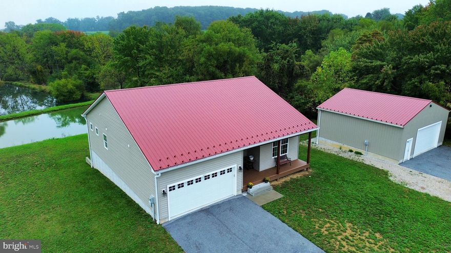 What a unique property! Multi-generational living is easy with this home on nearly 4 acres. With a three bedroom, two- bath main level and a two-bedroom, one-bath lower level, this home totals five beds and three full bathrooms. Each level has its own laundry area and kitchen. Constructed in 2021, it is still relatively new and in excellent condition. It offers neutral colors and newer mechanicals and appliances for efficient living. Enjoy the views of your very own ponds and wooded land from the rear windows and deck…. or walk right out to the pond from the lower level slider. And there’s more in the detached garage! The separate structure offers a small kitchenette and laundry hookups plus a full bathroom! This detached garage offers approximately 750 square feet of space, high ceilings, built-in storage shelving, and its own separate electric service. Let your imagination run wild with this property. Options abound!