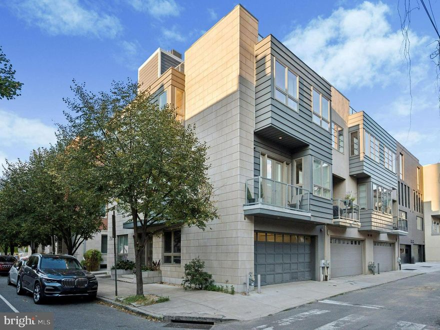 ***Striking 4-Story Contemporary Home with Designer Finishes***

Discover an extraordinary extra-wide residence that seamlessly combines modern architecture with luxury living. Built in 2013 by a premier builder for personal use, this one-of-a-kind home is filled with thoughtful upgrades and custom details at every turn. With three exposures flooding each floor with natural light, the interior feels bright, open, and inviting—delivering a rare lifestyle opportunity in one of Philadelphia’s most desirable neighborhoods.

The second floor serves as the centerpiece of the home, showcasing an expansive open-concept living area with dramatic Italian marble flooring, a sleek corner gas fireplace, and elegant French doors opening to a private deck. The adjoining chef’s kitchen is equally impressive, outfitted with high-end Italian cabinetry and top-tier appliances from Wolf, Miele, and Sub-Zero. Built-in espresso and steam ovens, an induction cooktop, and a wine refrigerator elevate both entertaining and everyday living.

Three spacious en-suite bedrooms include a versatile first-floor suite—ideal for guests, in-laws, or a private office. The primary suite offers a serene retreat with a spa-inspired bath featuring a deep soaking tub, oversized steam shower, wall-mounted Toto toilets, quartz countertops, and custom tilework.

Throughout the home, luxury details abound: rich mocha hardwoods, heated tile flooring, custom California Closets, and recessed LED lighting. Additional highlights include an oversized two-car garage, rooftop deck with sweeping Center City views, and modern smart-home amenities—multi-zone HVAC, full intercom/security system, energy-efficient Pella windows and doors, and an EV charger.

Practicality meets style with a full-size laundry room on the upper level and a fully finished lower level, ideal for a gym, media room, or play space, complete with ample storage.

Perfectly situated in Graduate Hospital, this home is just moments from Rittenhouse Square, Center City, and Philadelphia’s finest dining, shopping, and cultural destinations.  Showing will begin this Friday, March 6th.