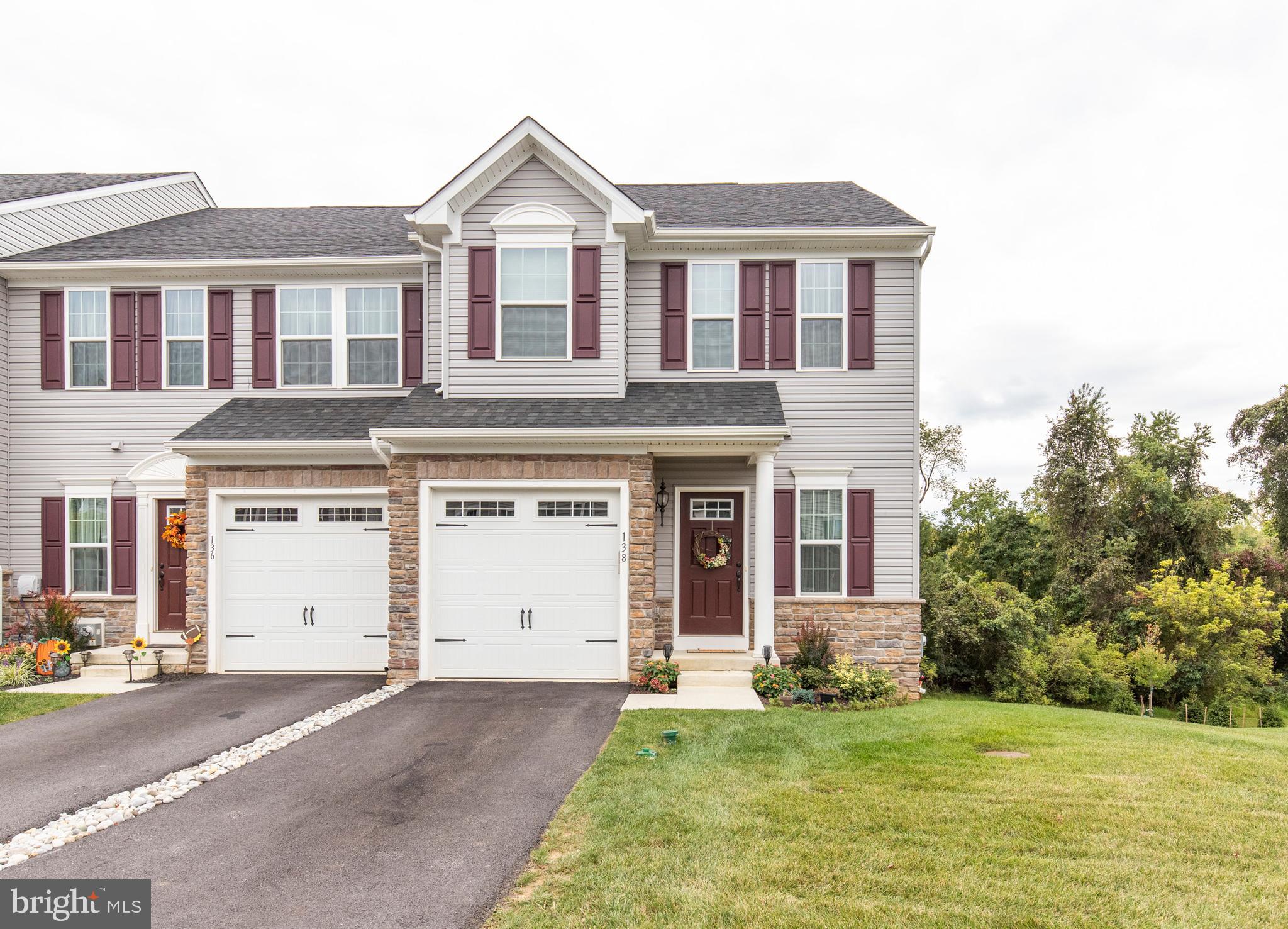 Are you looking for a new construction home, but you don't want to wait all those months until it's completed? Well, look no further than 138 Cricket Drive in Malvern! This home is a beautiful 1.5 year old end-unit townhome, which was built by Ryan Homes. Enter through the front door into the foyer and you're greeted with hardwood flooring which runs throughout the first floor. Along the hallway to the great room you will find an entrance to the garage, in addition to a powder room. The great room is complete with a large living room, dining area, and a spacious kitchen. The custom kitchen has dark brown cabinetry, stainless steel appliances, granite countertops, and a tile backsplash. The kitchen also features a spacious island with ample seating for over four people. The dining and living areas have plenty of natural light which shines in from the windows. In addition to the formal dining room, there is also a space for an eat-in kitchen area. A door to the deck completed the first floor. Outside on the deck, you will find sweeping views of the woods and plenty of room for seating and a grill. Upstairs you will find three bedrooms which all contain plush neutral carpeting. The master bedroom is located in the front of the house and contains two large closets including a walk-in. The master bedroom is also fitted with a tray ceiling and also a large master bathroom. The master bathroom contains a dual vanity with a granite countertop, a stall shower, and a soaking tub. Just outside the master bedroom you will find the hall bathroom which contains a shower/tub combination. Opposite of the hall bath is the laundry room. There are two more large sized bedrooms, both with ample closet space and natural light. The home has a finished basement, which would make a great future playroom, a second family room, or even an in-law suite, as it has its own independent access. The home s utilities are found with the basement, along with a full bathroom and a storage space. 138 Cricket Drive has one of the nicest lots in the community. The home has lush greenery views and is also located within the Great Valley School District. Don't wait to call this house your home!