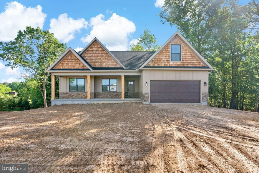 TO BE BUILT.  PERMITS IN HAND AND CONSTRUCTION TO BEGIN SOON.    PHOTOS ARE OF SIMILAR CONSTRUCTION AND MAY FEATURES UPGRADES THAT ARE OR ARE NOT AVAILABLE.  Welcome to this beautifully designed new construction home located on 2.4 private acres along Libby’s Ridge Road in scenic Berkeley Springs. The main level offers a spacious and functional layout featuring 3 bedrooms and 2 bathrooms, including a comfortable primary suite. The cathedral ceiling in the family room creates an open, airy atmosphere, perfectly complemented by a modern kitchen with stainless steel appliances, granite countertops, and ample cabinet space.
Upstairs, a finished bonus room adds incredible versatility—complete with an additional bedroom and full bathroom, ideal for guests, extended family, or a private office or studio.
The home also includes an unfinished basement, ready for future expansion or storage, and a 2-car garage with garage door opener for added convenience.
This property blends quality construction with a peaceful, wooded setting—perfect for anyone seeking privacy while still being close to the amenities of Berkeley Springs.