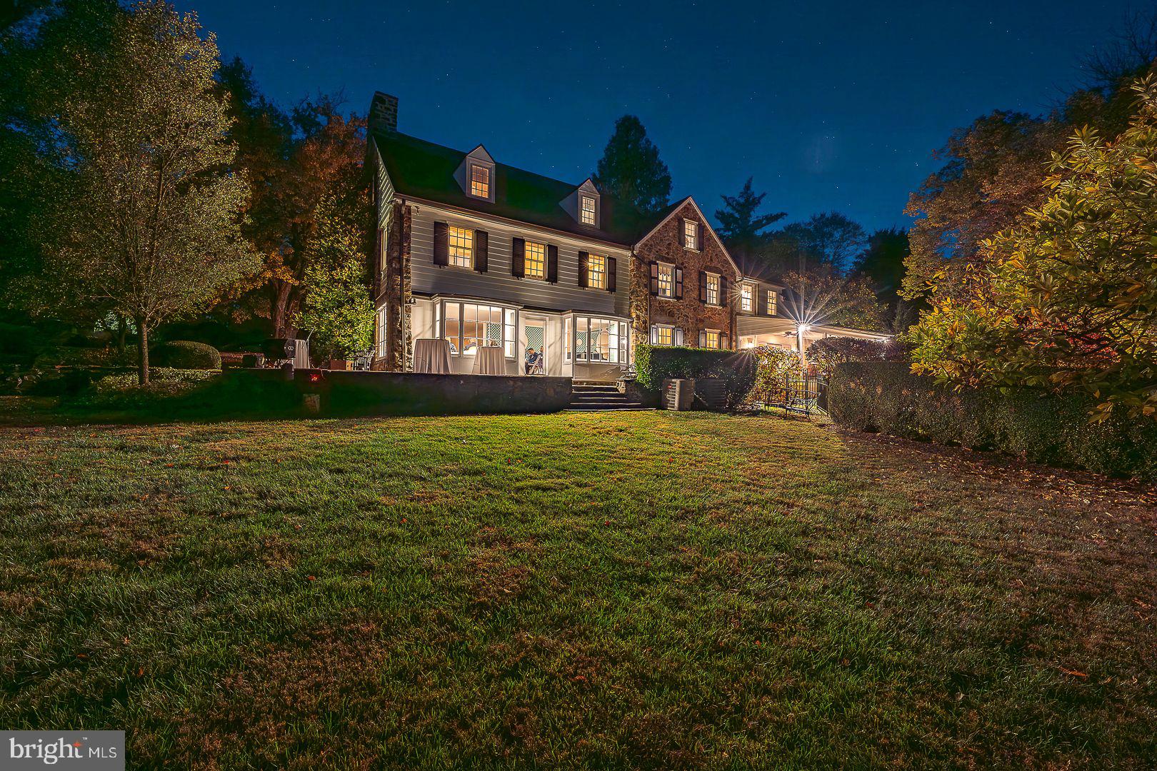 Welcome to 238 Curwen Rd, a quintessential 1920's Main Line Manor home nestled on a tranquil street in the heart of Bryn Mawr. This distinguished residence artfully marries the architectural grandeur and craftmanship of a bygone era with thoughtful modern enhancements, offering a refined living experience for the most discerning buyer. Set on over 2 acres of park-like grounds, this estate is a private retreat featuring stone terraces, a heated pool, lush perennial gardens and even your own putting green. With over 7,000 square feet of living space, this home provides an expansive and inviting environment, including 5 to 6 bedrooms, 6 full baths and 2 half baths. Upon entering, you're greeted by a spacious foyer that opens into a large living room with a wood burning fireplace, perfect for cozy evenings. The adjacent sunroom, bathed in natural light, offers a serene space to unwind. The formal dining room, adorned with exquisite millwork and deep windowsills, is ideal for hosting memorable gatherings. The cook's kitchen is a chef's dream, complete with a Butler's pantry, a large butcher-block island, a Wolf range, and both a Sub-Zero refrigerator and freezer. The breakfast area flows seamlessly into a spacious family room, featuring a gas fireplace, sliding doors to a screened porch, and 2 built-in desk areas, making it a hub for both relaxation and productivity. The second floor is home to the Primary Suite, a private sanctuary with its own wood-burning fireplace, dual offices, a dressing room and a luxurious Primary bath. This level also includes a laundry room and 2 additional bedrooms with ensuite baths. The 3rd floor offers a large bedroom, a full bath and an additional bedroom or playroom, providing flexible spaces for family and guests. Over the garage, a renovated space includes a large exercise /playroom, a tv loft, a bedroom and bath and a convenient kitchenette. The finished basement adds even more space featuring a full bath and direct access to the pool. This residence is the epitome of classic elegance, perfectly blended with the amenities essential for today's lifestyle, making it the ideal home for those who appreciate timeless beauty and modern convenience.