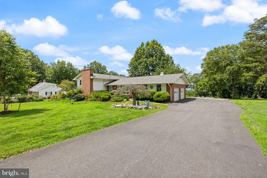 Welcome to this beautifully updated 4-level split home in sought-after Braddock Heights, MD, offering sweeping views of the Middletown Valley. This mid-century modern gem blends timeless charm with today’s comforts .Many original details remain, preserving the home’s unique character, while major systems have been upgraded for peace of mind.  Inside, you'll find 3 spacious bedrooms and 2.5 bathrooms, along with thoughtful updates throughout. The light-filled kitchen features high-end appliances, perfect for cooking and entertaining. Gleaming hardwood floors flow through the main living  areas and bedrooms, while durable LVP flooring adds style and function to the lower level. The spacious family room features a wood-burning fireplace. You might actually enjoy doing laundry in the large, bright laundry room with utility sink and direct access to the backyard — ideal for everyday convenience. The unfinished basement level has plenty of storage space and a large cedar closet. Step outside to a private patio space, perfect for relaxing or hosting friends. You will want to show off the attached garage  with its epoxy floors, plenty of storage, and a 220V plug ready for your electric vehicle.  Updates include the resurfaced driveway (2021),(mostly) new windows, a new roof (2024), a new heat pump (2024), a new well pump and pressure tank (2022), new hot water heater (2021).  The heat pump offers central heat and air conditioning with radiant ceiling electric heat backup for the coldest days. 
Don’t miss this rare opportunity to own a stylish, move-in ready home with incredible views and thoughtful upgrades in a great location.