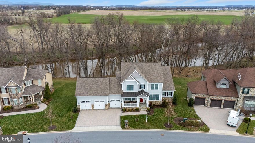 The River View Estates at Mill Island - this customized home offers unobstructed River views and scenic vistas - 2 private decks and full walk-out lower level with full size windows and 2 double walk-out exits, this unfinished space has a full bath rough-in and rough-in for a wet bar. Enter from a covered front porch and you are greeted by an open plan with huge windows to a large open porch taking advantage of the sweeping views from a 2-story great room with fireplace. The GR is open to the kitchen with a 10-foot island perfect for gathering, and an informal dining room/breakfast room with walls of windows to take advantage of the scenic water views. Off the kitchen is a large mudroom, walk-in pantry, and private deck tucked behind the garage perfect for morning coffee. A main level primary suite is complimented by walk-in closet and spa bath with free standing soaking tub and huge walk-in shower plus additional closet storage! Ascend to the second level from an atrium room/open staircase to the second level with 3 additional bedrooms and 2 baths. Truly a remarkable setting, home and community. Located on Mill Island with a large nature preserve, enjoy a quiet neighborhood bounded on one side by the Monocacy River and the other by Tuscarora Creek; once you cross the bridge onto the island leave your cares behind. No thru traffic, miles of paved marsh trails in a protected wildlife area to jog or stroll offer a sense of quiet solitude. There is also an area to launch kayaks on the Monocacy side. Resort amenities include a clubhouse featuring areas to lounge and entertain, a workout room, Game room, locker rooms, library, adult pool, kids pool, lap pool, tennis courts and putting green. Stroll to the Worman's Mill Town Center for indoor and outdoor dining at local restaurants, convenience stores, a town square with outdoor weekend summer concerts and food trucks.