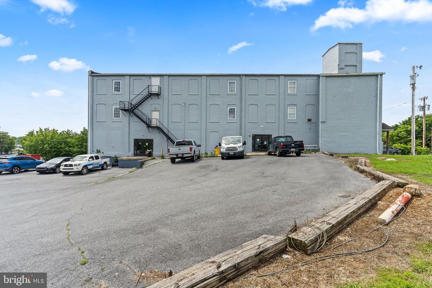 Nestled in the heart of Hagerstown, the all-brick, 4-story Block Enterprises building oﬀers a prime opportunity with over 19,000 sq ƞ of versatile space on a 1.01-acre lot, zoned for Industrial use and conveniently situated next to Steﬀey & Findlay. This property, featuring two loading docks, is ideally suited for a variety of purposes including IOS storage, warehouse, light industrial uses, manufacturing, oﬀice space, or as a lucrative investment. Fair market rent in this section hovers around $6 to $12/SF. The building accommodates a range of space needs, from single rooms and oﬀices to large open areas, making it perfect for both small businesses and large corporations. It is equipped with comprehensive safety and accessibility features, such as 36"+ wide halls, a brand new elevator, exterior cameras, a main entrance lock, monitored security, motion detectors, smoke detectors, and an indoor sprinkler system. The third floor, with its 14 foot ceiling heights, shared men's and women's bathrooms, and two water fountains, adds to the convenience for all users. Recently upgraded with a new HVAC system, water heaters, windows, and fresh paint, the building is in very good condition. Spanning 16,000+ sq ƞ across above ground levels of brick/stone construction, the fully rented finished areas, along with additional spaces ready for build-out, present a significant opportunity for increased rental income. Additional amenities include a new fire escape, overhead doors, conveyors, fencing, and blacktop, all oﬀered at an exceptional price of $900,000. This prime commercial real estate is not only flexible and manufacturing-friendly but also perfectly suited for professional oﬀices, warehouses, or creative spaces like a dance studio. With the airport less than 10 miles away and a bus stop less than 1 mile, the location ensures convenient transportation options for any business. The property oﬀers endless potential with a wide range of possible uses. Strategically positioned within two miles of the new Amazon Fulfillment Center, Lowe's Home Improvement, and other key commercial hubs, this property ensures unparalleled access to major retail and distribution networks, marking it as a standout opportunity in Hagerstown. Easy lease up and cash out.