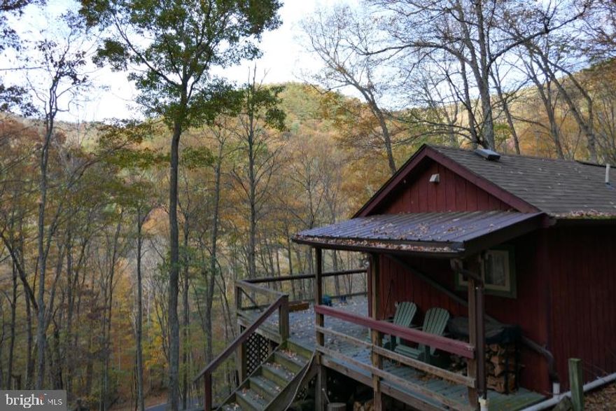 This little red gem of a cabin is tucked away among the trees offering plenty of privacy and opportunities for viewing wildlife.  There are 2 beds, 1 bath and a loft in this darling hideaway cabin.  The wood interior and the efficient wood stove keep this cabin as cozy as can be in the cooler months. Sit out on the spacious deck and be enveloped in nature as you feel all the pressures of daily life melt away. This property has electric, septic and 1700 gallon Cistern.