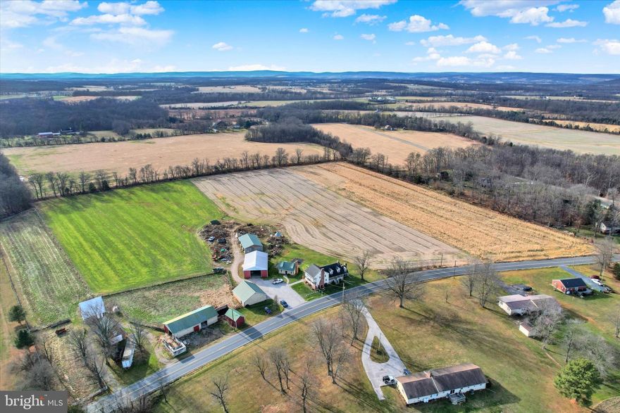 Welcome To This Exceptional 23.1 Acre Farm Offering The Ideal Blend Of Agricultural Opportunity, Cozy Living, And Rural Charm.  Suited For Horses, Cattle, And Crop Production, The Expansive Property Is Enrolled In The Clean & Green Program, Providing Valuable Tax Savings.  The Main Residence Has 3,416 Sq Ft Of Living Space With 6 Bedrooms, 3 Full Baths, And 2 Half Baths. A New 2025 Boiler System Ensures Comfort And Includes Radiant Floor Heating In The Additions. Inside Features 4 Fireplaces, Multiple Inviting Areas, And Warm Traditional Character Throughout. Enjoy Outdoor Living With Several Porches And A Patio With A Built-In Pizza Grill.  The 36x40 Four-Bay Detached Garage Provides Space For Up To Six Vehicles And Ample Storage. Additional Structures Support A Wide Range Of Uses, Including A 40x60 Pole Building, 36x40 Equipment Shed, And A 36x60 Outbuilding Designed To Feed Multiple Cattle. For Equine Needs, The Property Includes Two 26x30 Horse Barns, One Equipped With Three Horse Stalls.  A Standout Bonus Is The 1,140 Sq Ft Guest House Offering 1 Bedroom, 1.5 Baths, A Full Kitchen, Living Area, Washer/Dryer Hook-Up, Radiant Floor Heating, And Its Own Fireplace. This Is Well-Suited For Extended Family, Guests, Or Rental Income. This Is Truly A Rare Opportunity To Own A Well-Maintained, Fully Functional Property In Move-In-Ready Condition. Whether You’re Expanding Your Agricultural Operations Or Seeking A Country Setting, This Property Delivers It All.