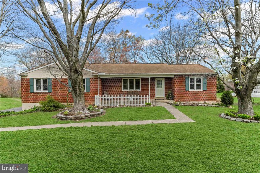Welcome to this solid 3-bedroom, 3.5-bath brick front ranch nestled on a lovely 1.1-acre lot in the heart of the Avon Grove School District. Step inside to a nicely sized living room featuring classic parquet flooring, which flows throughout most of the main level, adding timeless character and warmth. (with a light sanding and refinish they will be absolutely gorgeous)

The kitchen was tastefully updated in 2012 with granite countertops, Kraftmaid cabinetry,  and a center island with a butcher block top and a pop-up shelf—perfect for your KitchenAid mixer! The open design continues into the dining room, which features French doors leading to a bright and inviting 3 season room, ideal for morning coffee, crafting, or puzzle time. A convenient stairway leads from the sunroom to the backyard for easy outdoor access.

Relax in the cozy family room with a wood-burning brick fireplace—perfect for chilly evenings. The owner's suite offers a private bath, while two additional bedrooms share a full hall bath. A powder room and main-level laundry add extra convenience and complete the main level.

Downstairs, the daylight walk-out lower level is partially finished and ready for your personal touch. With some new flooring and TLC, it could be transformed into an amazing rec room,  french door access to the screened porch and rustic bathroom. There's also a utility/storage room and oversized two-car garage with plenty of space for vehicles and tools.

Outside, enjoy the peaceful setting surrounded by mature landscaping and colorful blooms from spring through fall. This home offers the perfect blend of comfort, functionality, and potential—all in a sought-after location. Move right in and start building sweat equity as you make this home your own! The property is being sold "as is" to settle an estate. Inspections are welcomed, however seller intends no repairs. The estate is still removing the last contents of the home, home will be totally emptied prior to settlement.
