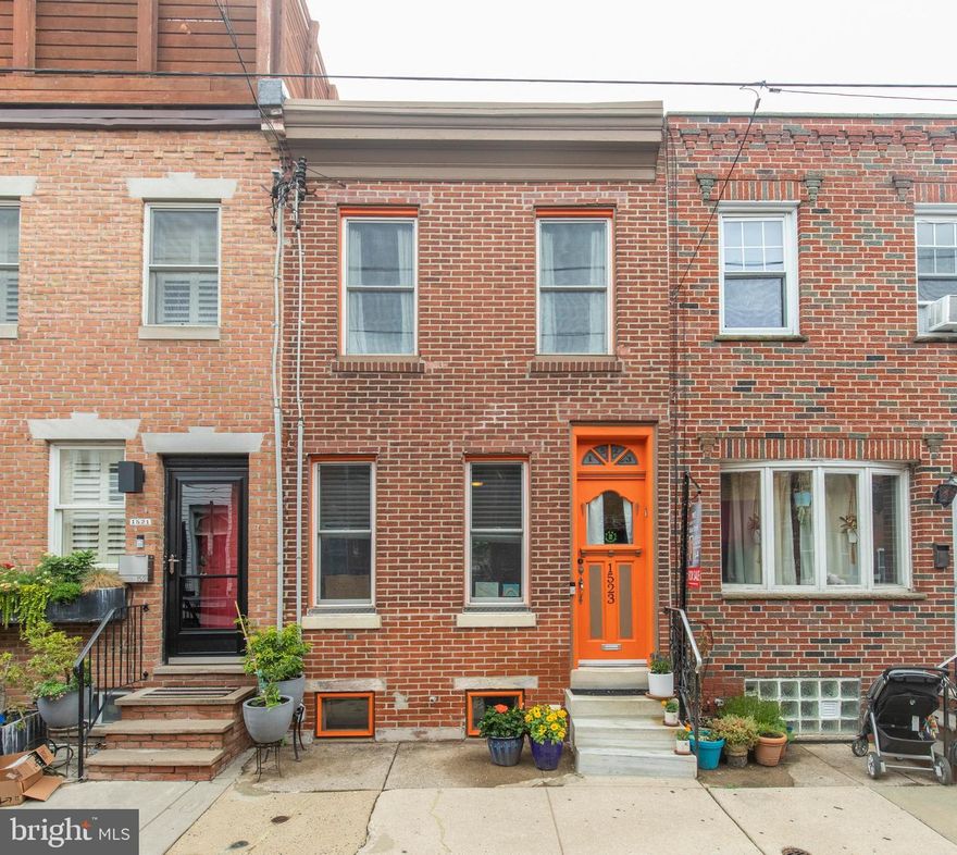 Welcome to this charming 2 bed, brick front East Passyunk gem! Original details are still in place at this lovely home, from the original door, to the woodwork, to the original hardwood floors, there is so much character here!  Walking in, you will enter into a large and brightly lit living room, and your eye is immediately drawn to the beautiful trim, archway, and moulding on the ceiling.  Passing underneath the scalloped detail, you walk into the dining room, and through that into the brightly lit kitchen. Your oversized, new 33" stainless steel sink sits beneath a large window, which faces a beautiful yard. The countertops are well maintained butcher block, with a lazy susan in the corner, and a new dishwasher.  Passing into the yard through the extra wide back door, you'll find a well-kept patio with a custom made gate into the alley.  The brightly lit patio is perfect for a garden, or for a young one to play. Directly outside of the kitchen, you'll find storage space and the entry to the basement, where your laundry is. On the second level is a large bathroom with tons of space! The two bedrooms are both decently sized, both getting a fair amount of natural light.  The block is filled with wonderful neighbors, and this house actually won Stoop of the Month last November! Less than one block from the Broad St Line subway and only a few blocks from the Singing Fountain, this is an ideal location! Make your appointment to see this gorgeous, character-filled home today.